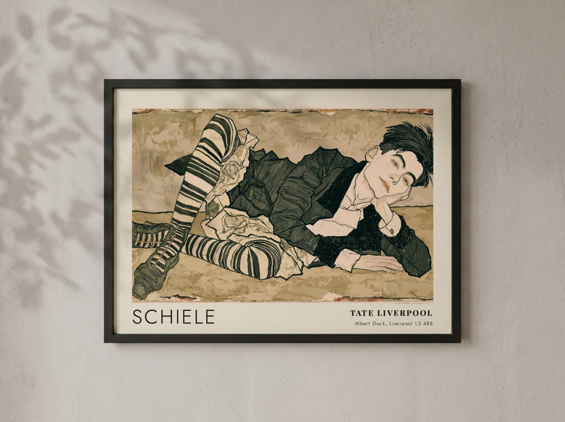 Wall art poster featuring an Egon Schiele portrait with striped stockings and text.