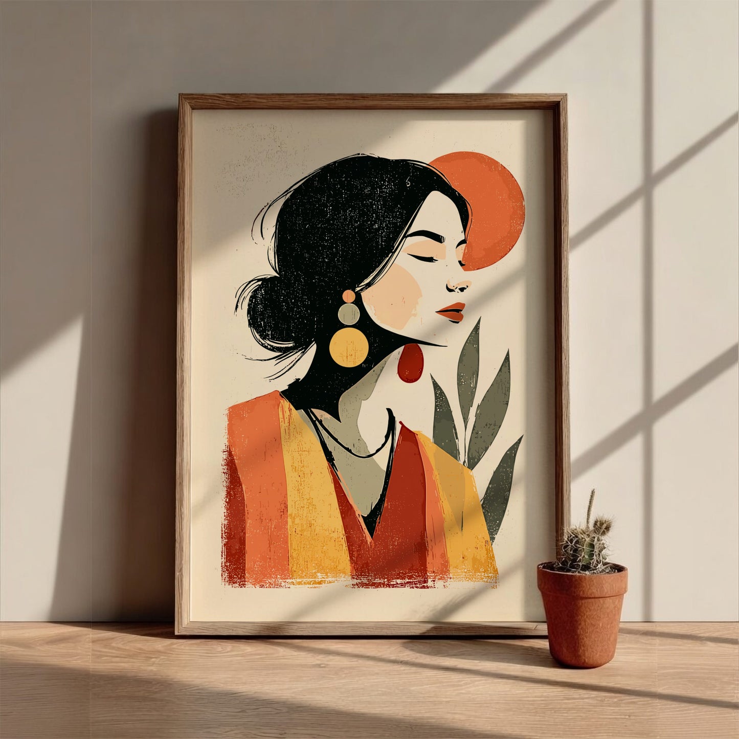 Framed artwork of a stylized woman's portrait on a wooden surface with a plant.