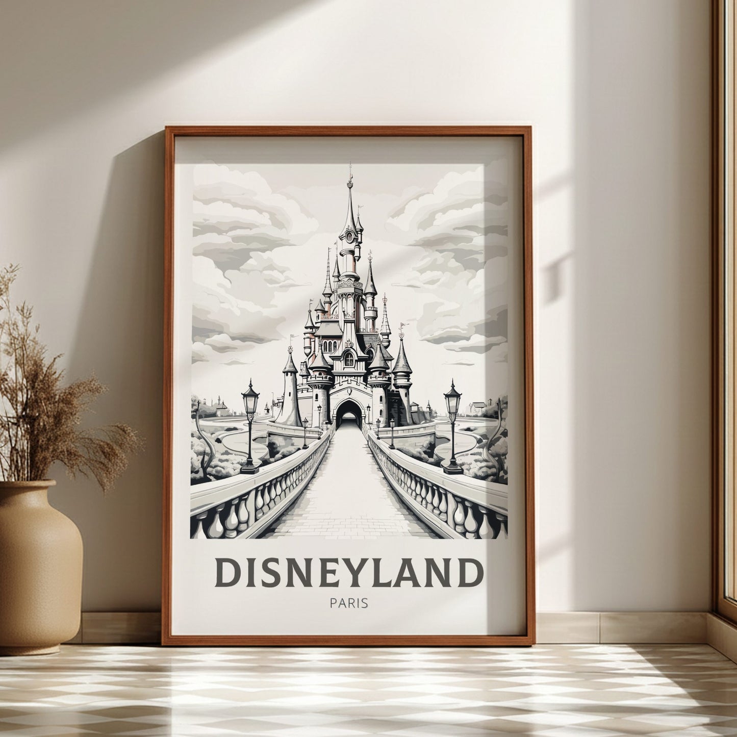 Framed artwork of Disneyland Paris castle on a wall with a vase and plant.