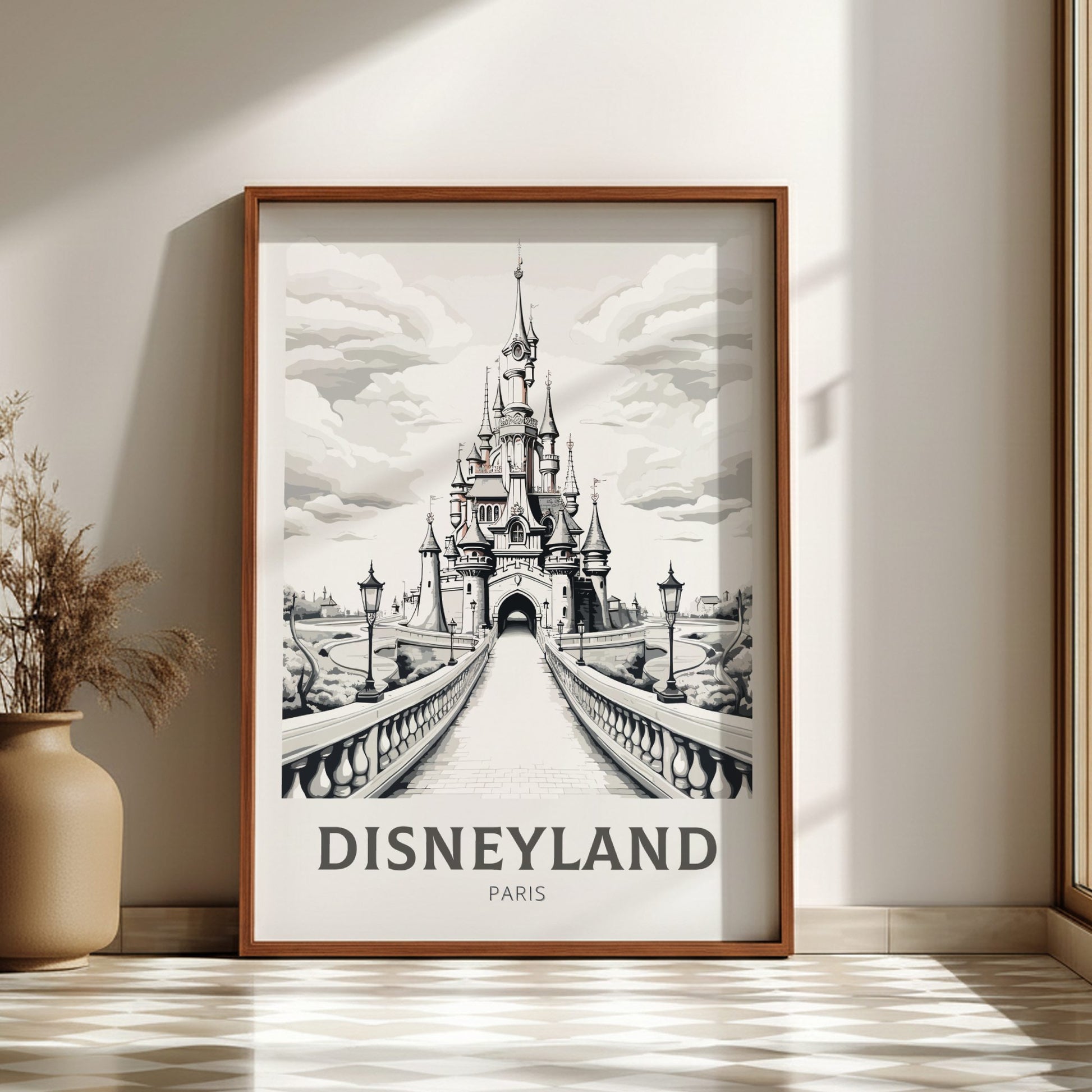 Framed artwork of Disneyland Paris castle on a wall with a vase and plant.