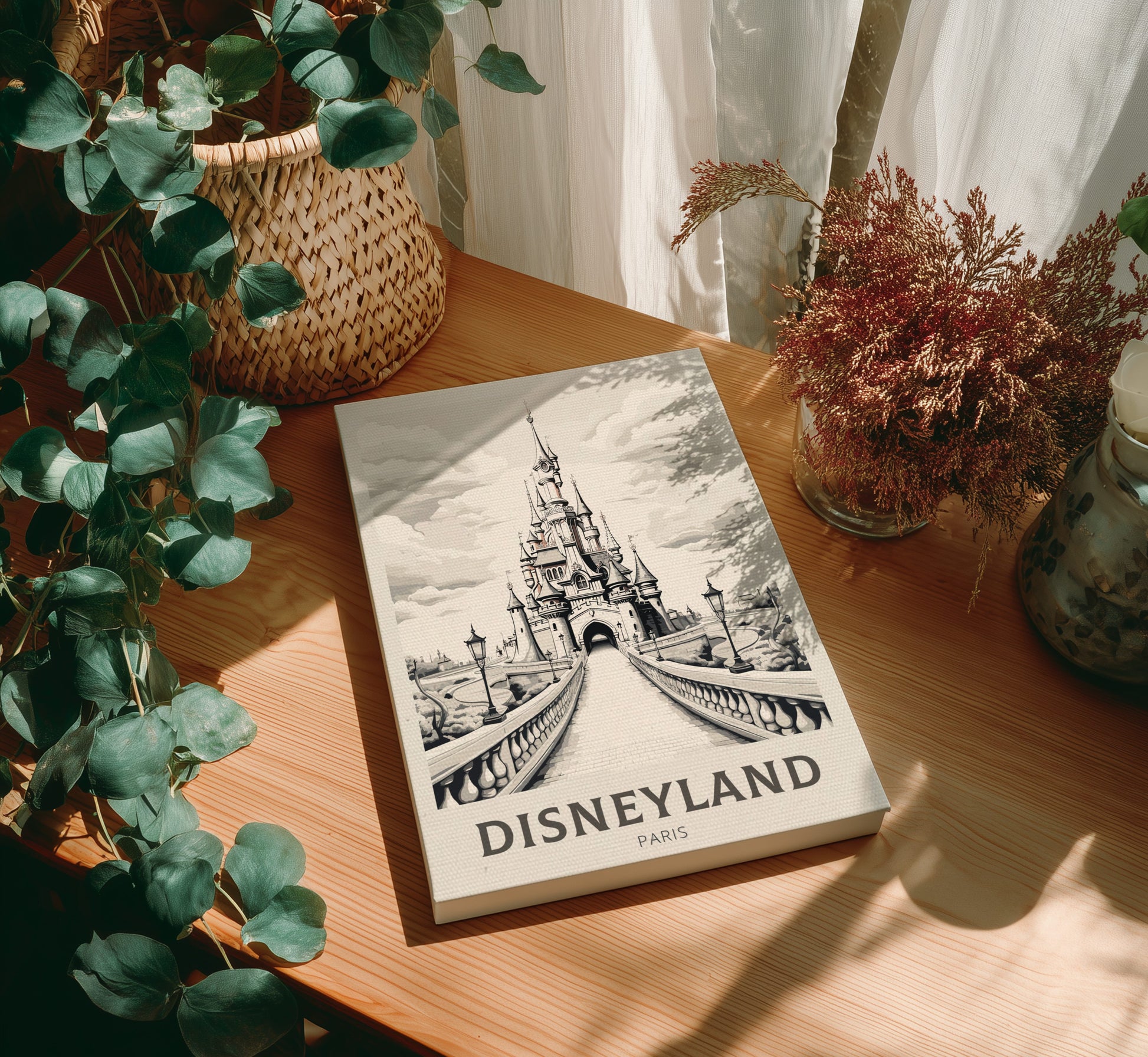 Canvas 'Disneyland Paris' on a wooden table with plants