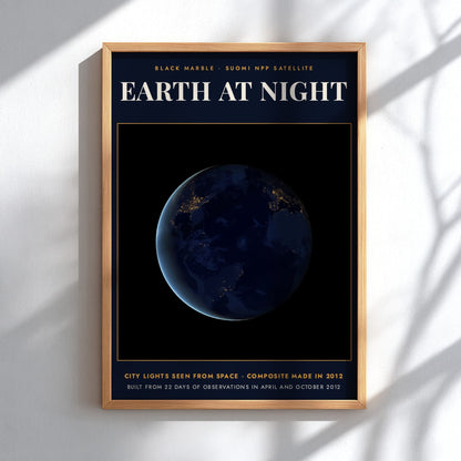 Poster featuring a dark Earth at night with glowing yellow city lights from space.