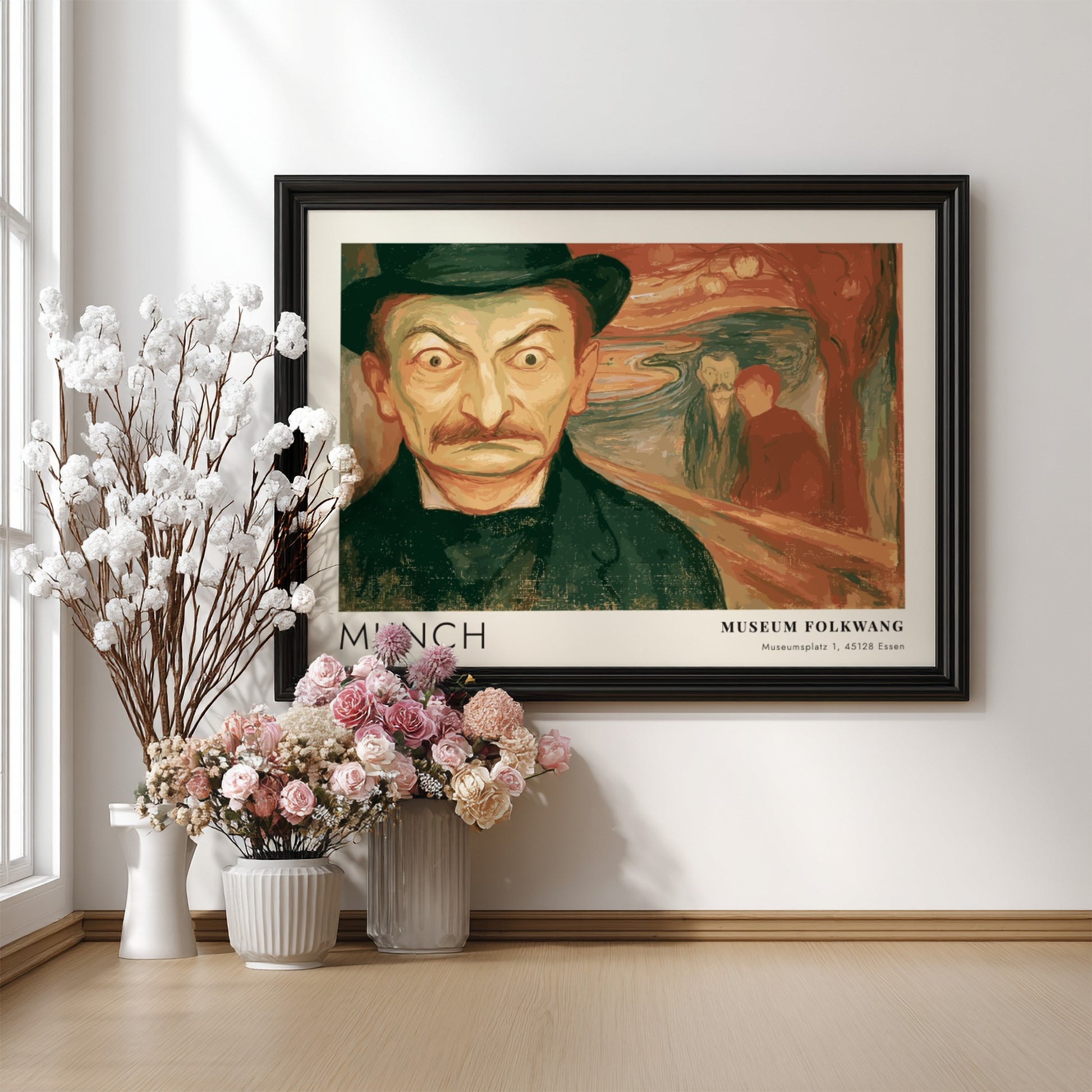Exhibition poster featuring a wide-eyed man by Munch in a wooden frame display.