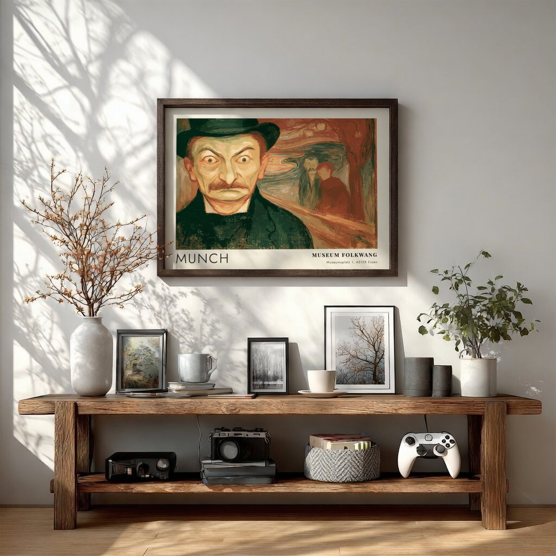 Exhibition poster featuring a wide-eyed man by Munch in a wooden frame display.