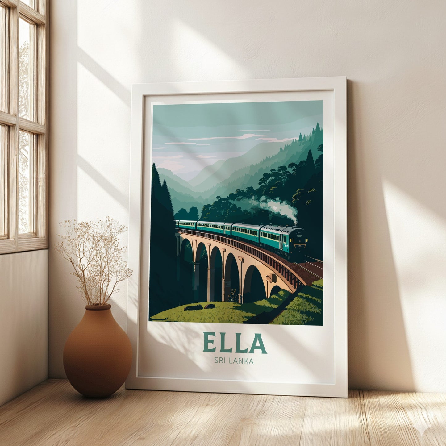 Framed artwork of a train on a bridge with 'Ella, Sri Lanka' text in a room with natural light.