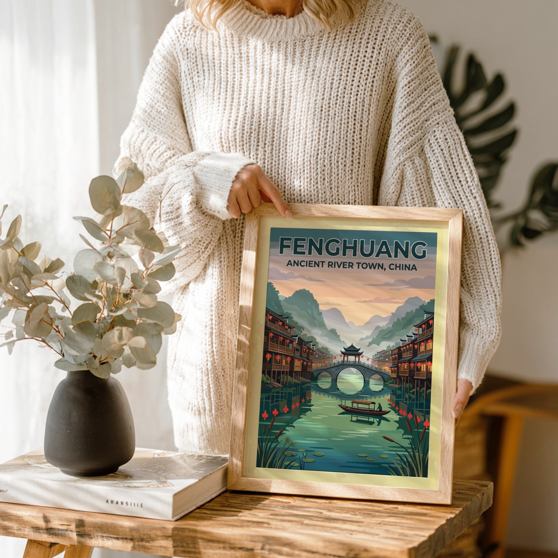 Travel poster of Fenghuang Ancient River Town with traditional stilt houses and bridge.