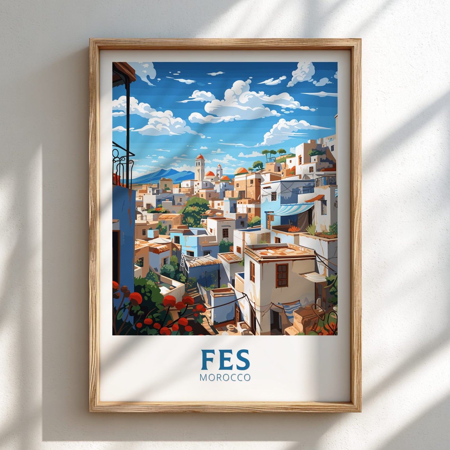 Framed artwork of Fes, Morocco with a wooden frame on a white wall.