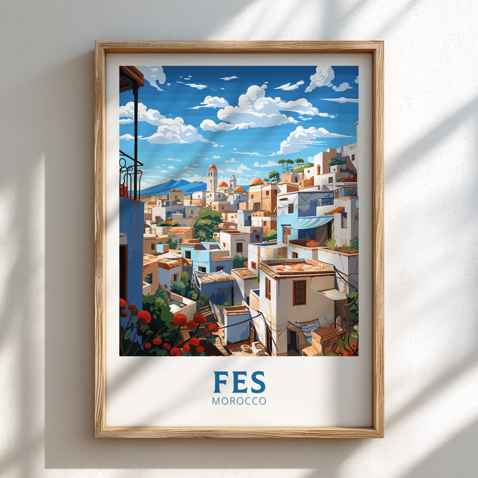 Framed artwork of Fes, Morocco with a wooden frame on a white wall.