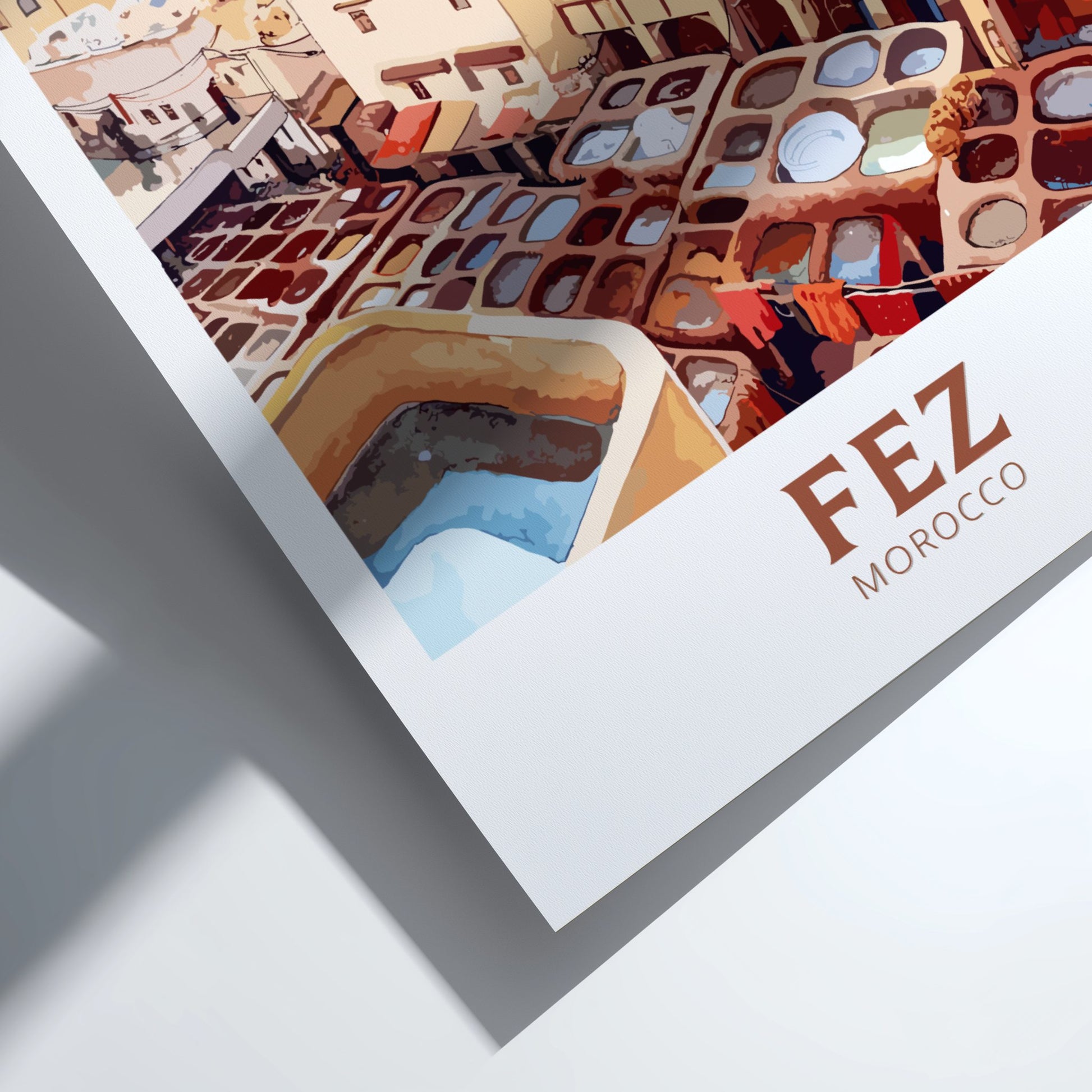 Framed artwork of a colorful architectural scene with 'FEZ MOROCCO' text.