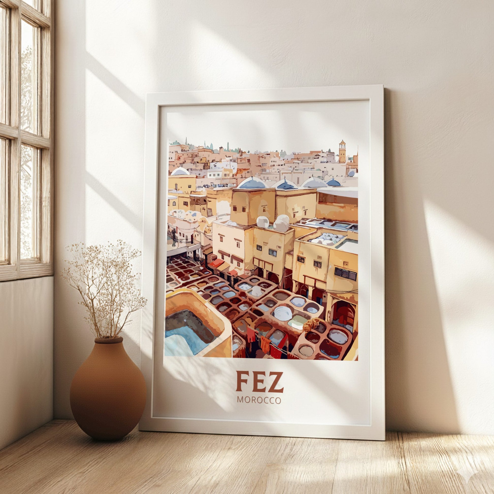 Framed poster of Fez, Morocco with a vase on a wooden floor.