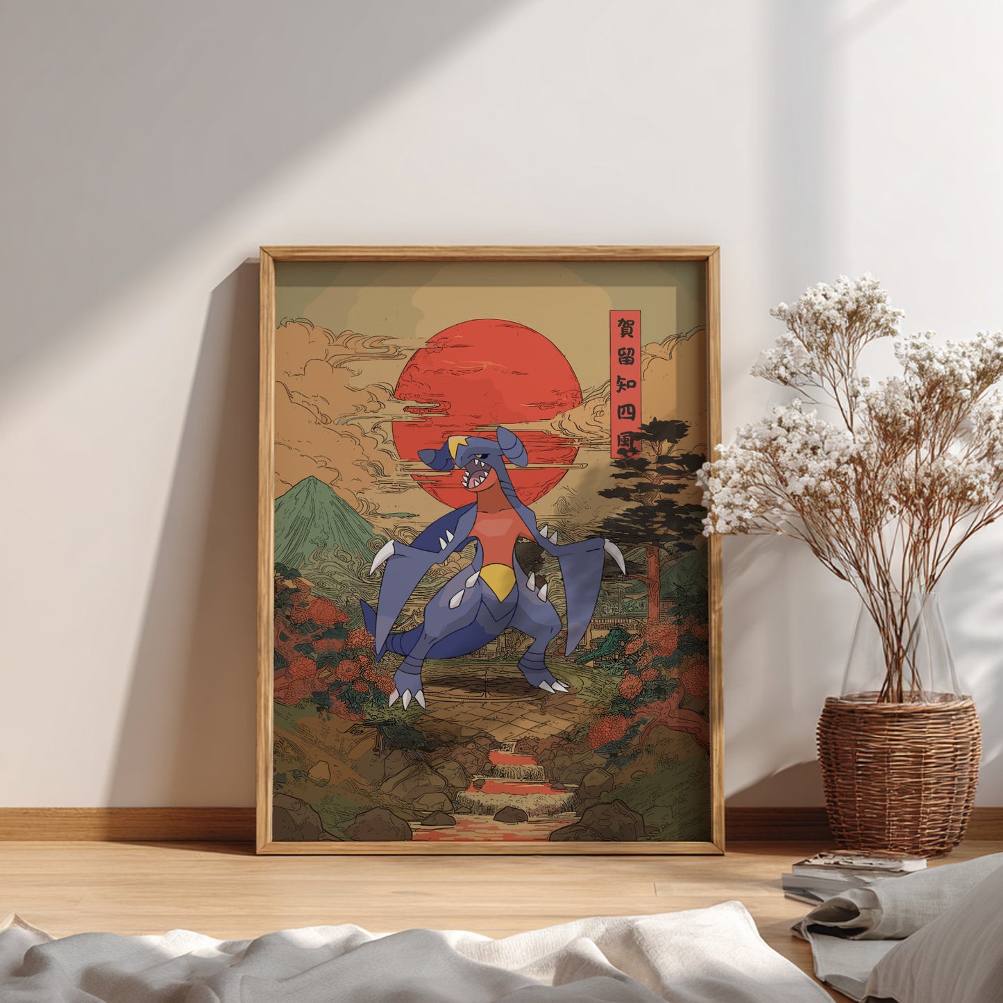 Framed artwork of Garchomp Pokemon  with a red sun and mountains in a room with a plant and books.