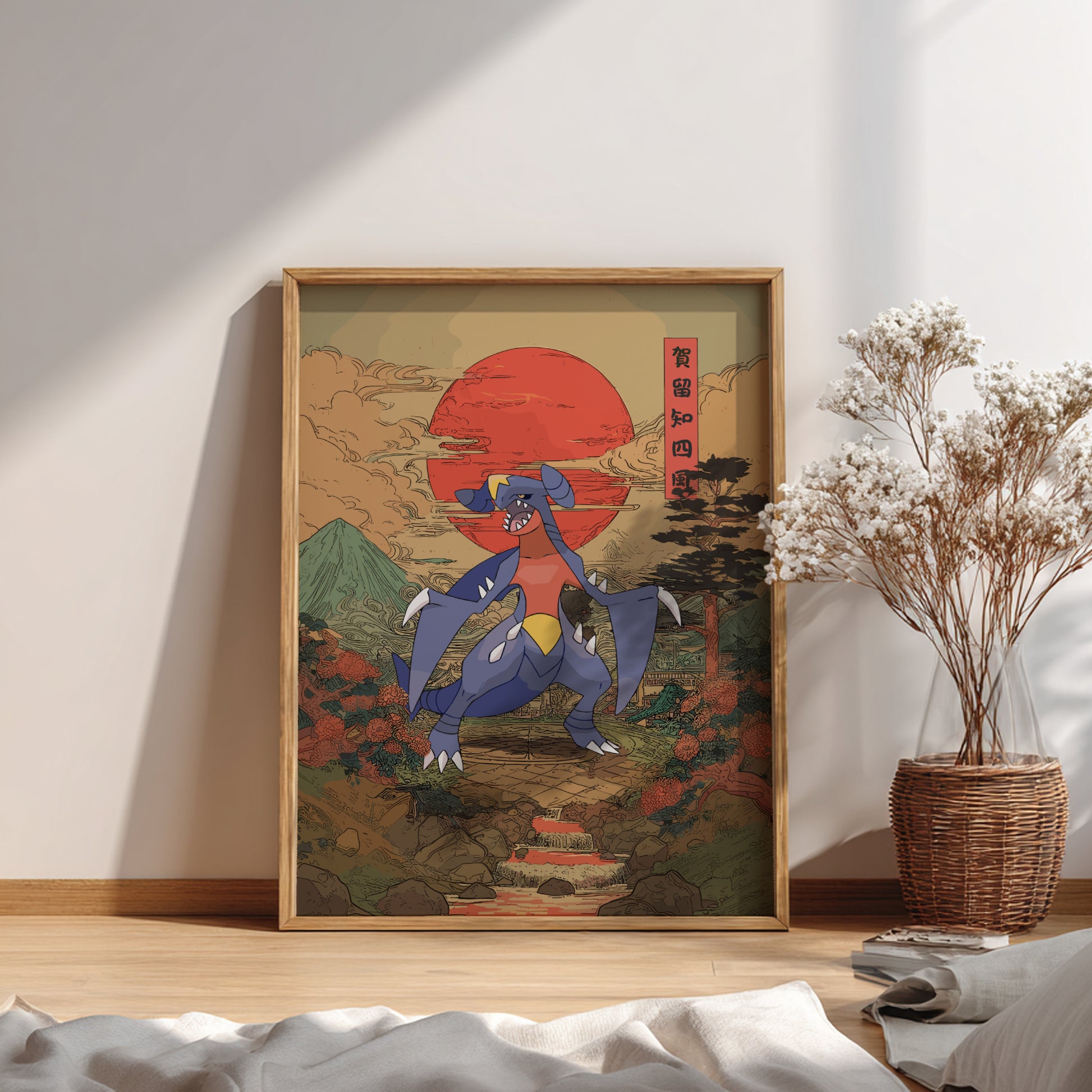 Framed artwork of Garchomp Pokemon  with a red sun and mountains in a room with a plant and books.
