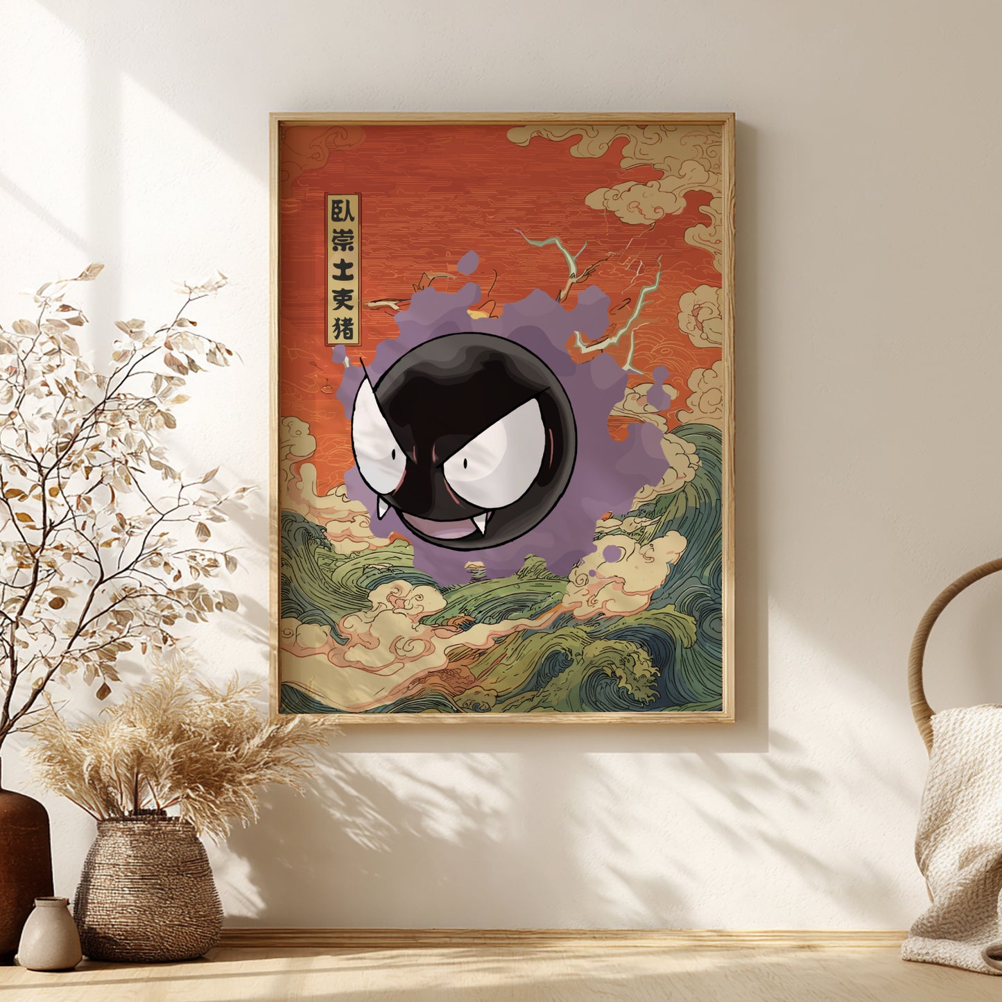 Framed artwork with a stylized Gastly Pokemon on a red background, placed on a wall with decorative elements.