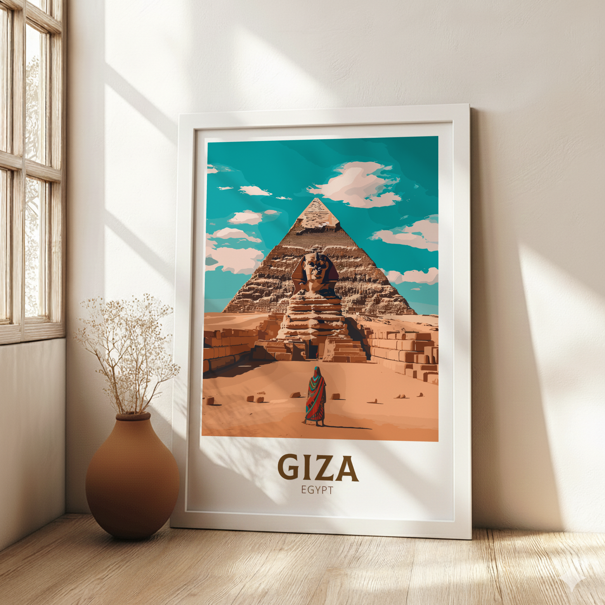 Framed poster of the Pyramids of Giza with a person and Sphinx, placed on a wooden floor.