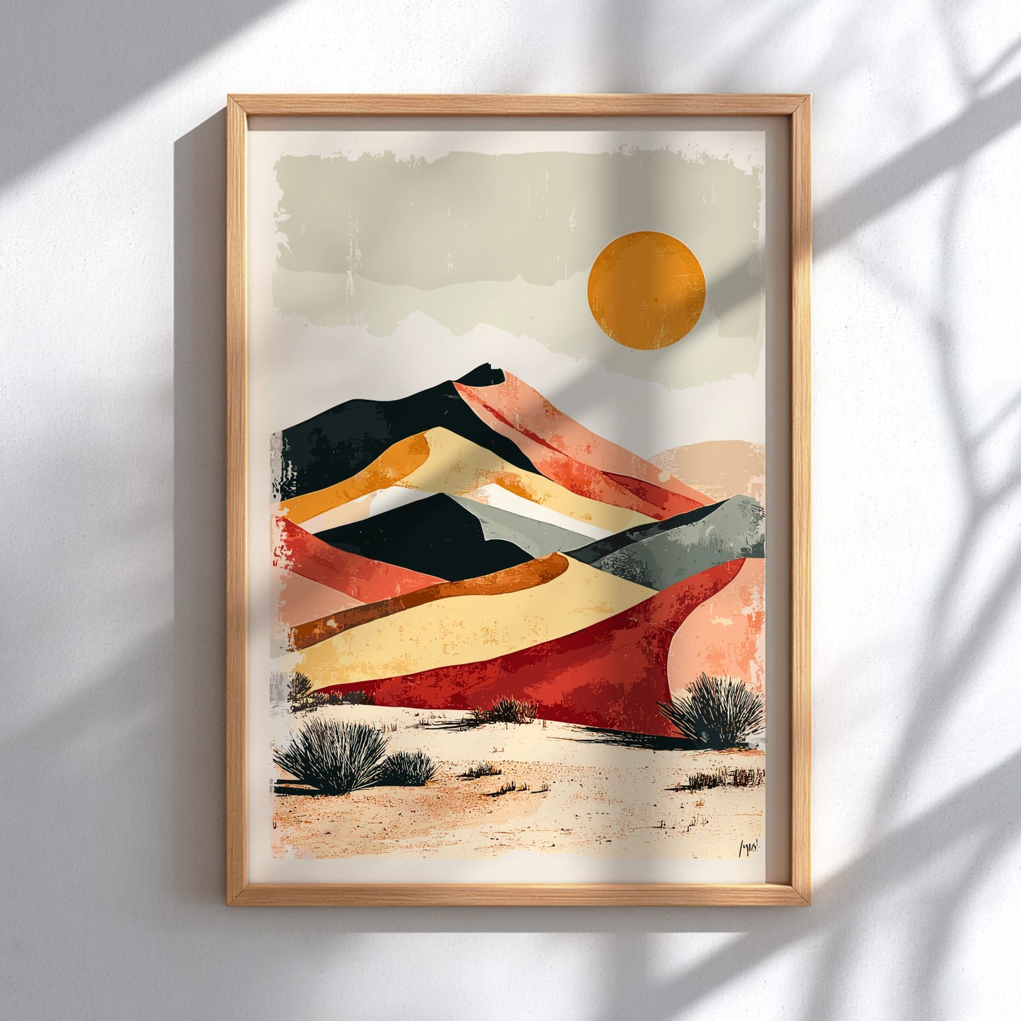Framed abstract art of a desert landscape with colorful stripes and a sun on a white wall.