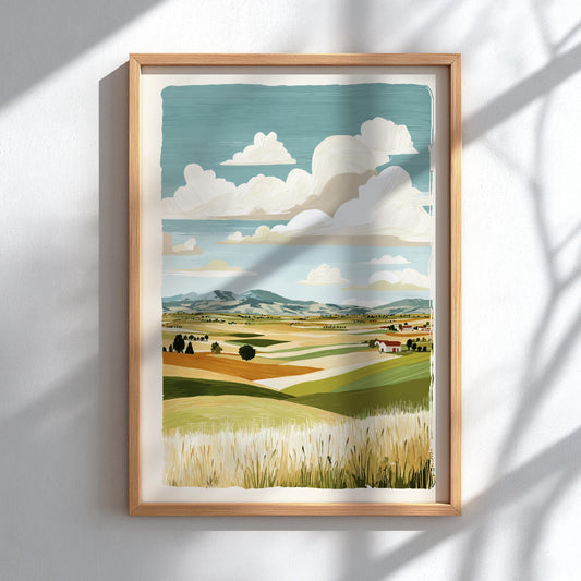 Framed artwork of a landscape with fields and clouds on a white wall.