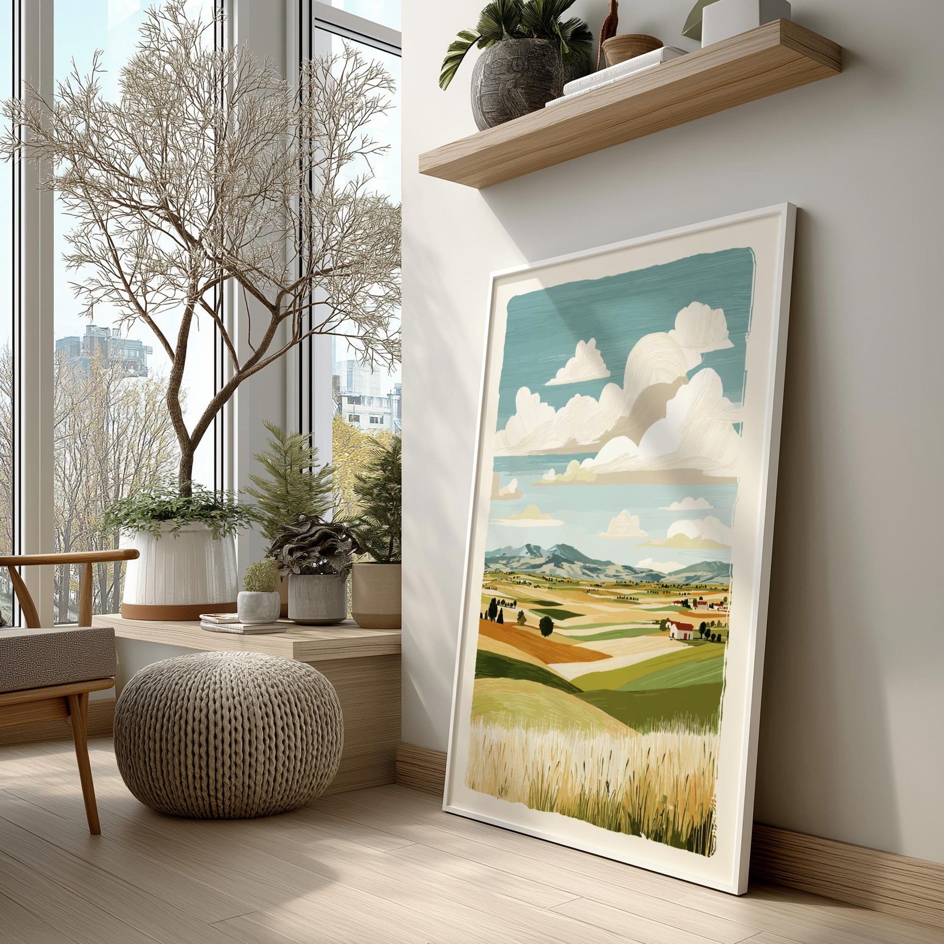 Framed landscape print on a wall in a room with large windows and indoor plants.
