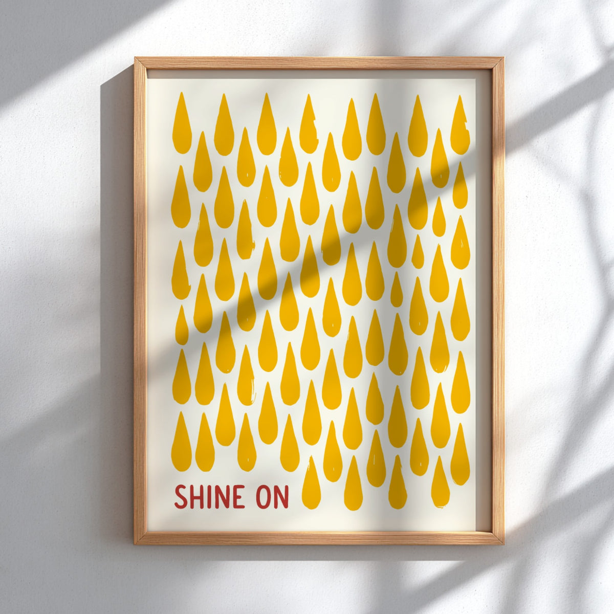 Motivational poster with yellow raindrop patterns on cream background and Shine On text