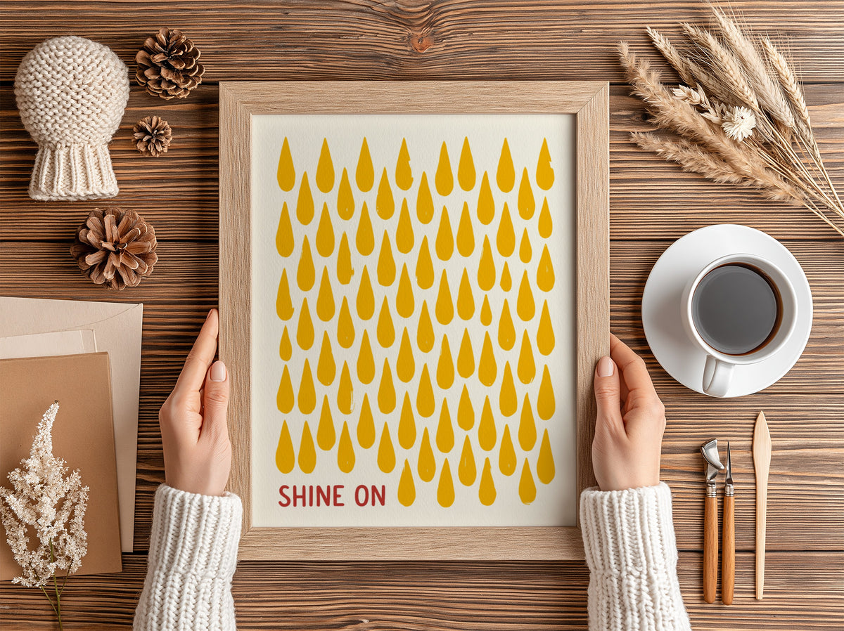 Motivational poster with yellow raindrop patterns on cream background and Shine On text