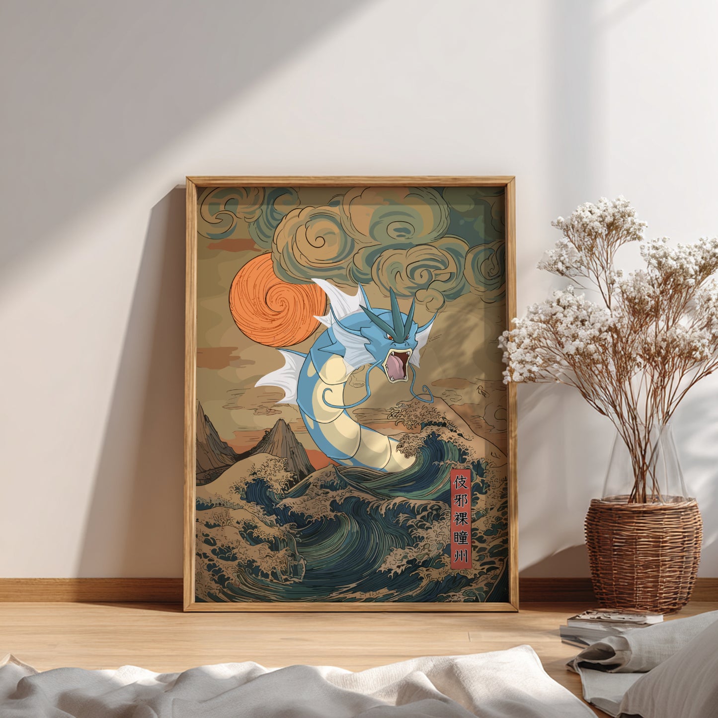 Framed artwork with Gyarados Pokemon design on a wall in a room with a plant and books.