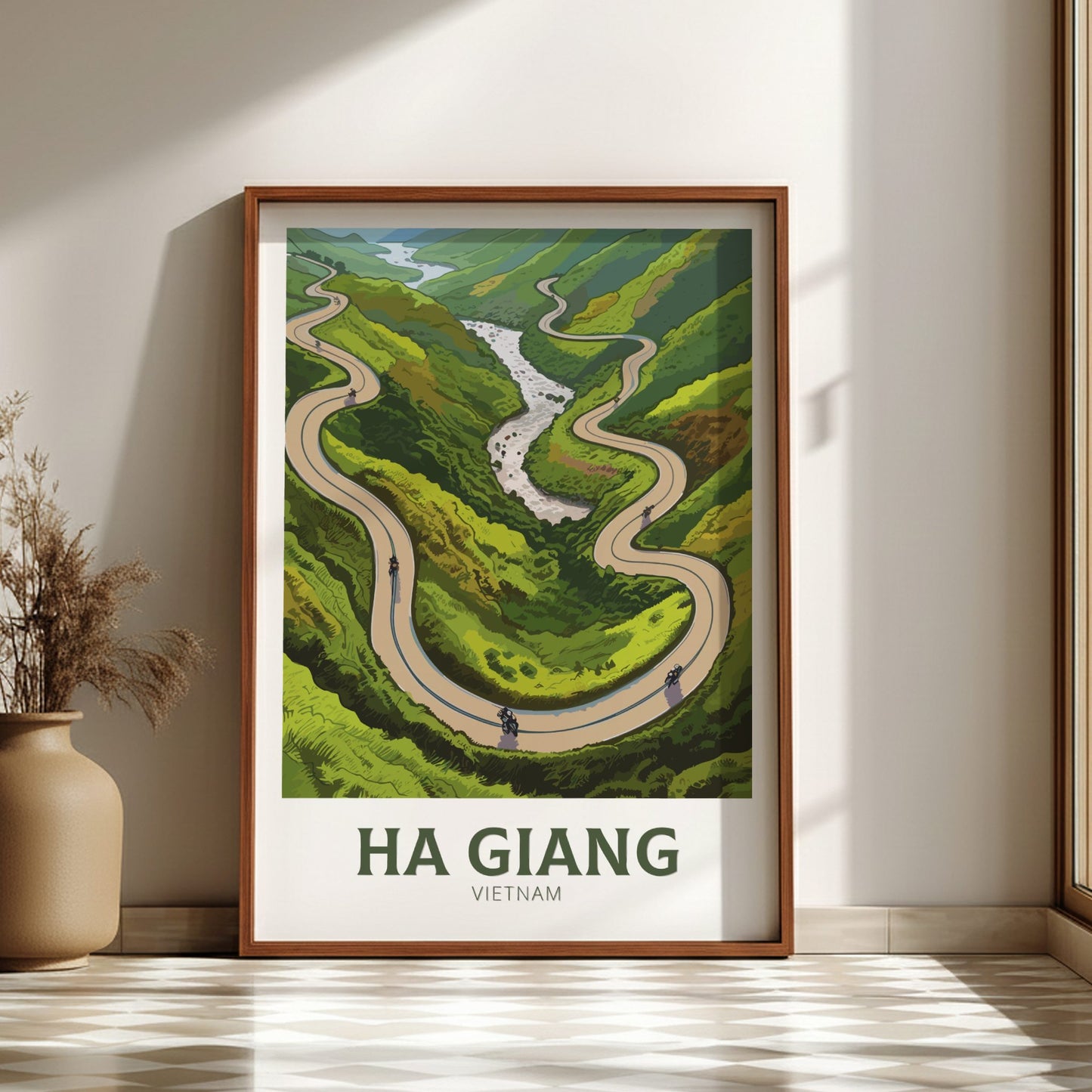 Framed poster of a winding road in Ha Giang, Vietnam on a wall.