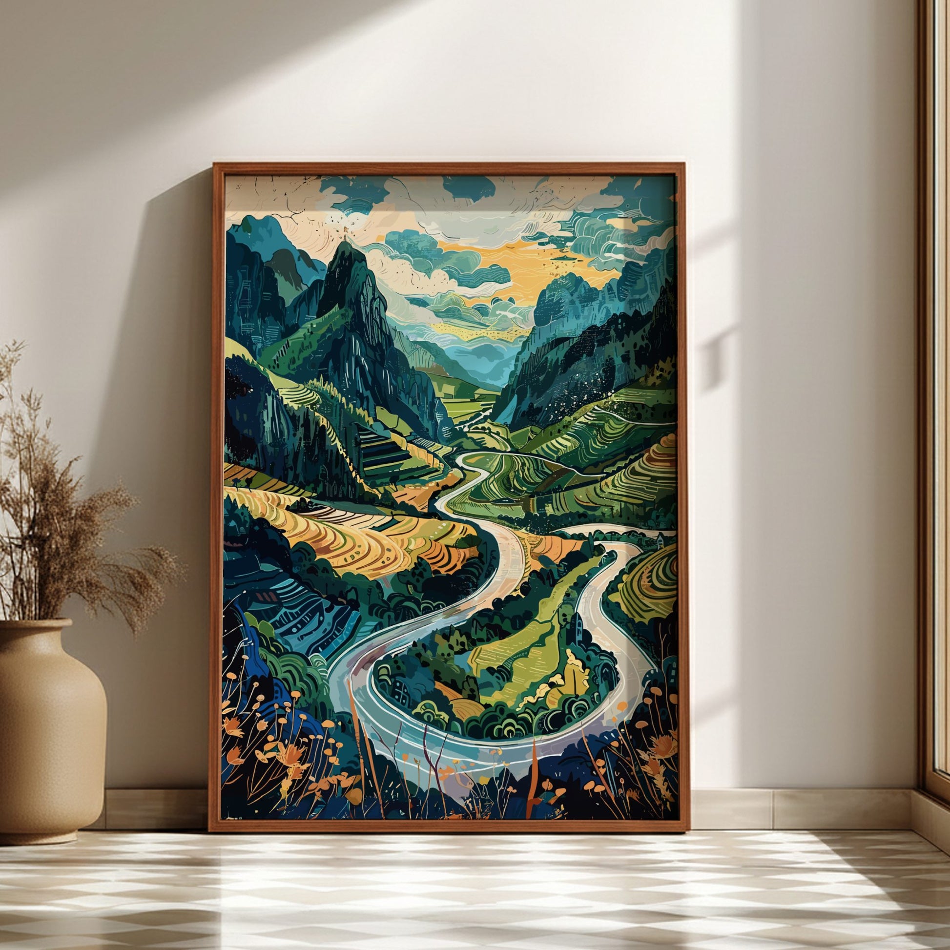 Framed artwork of a mountain landscape with a winding river on a wall.
