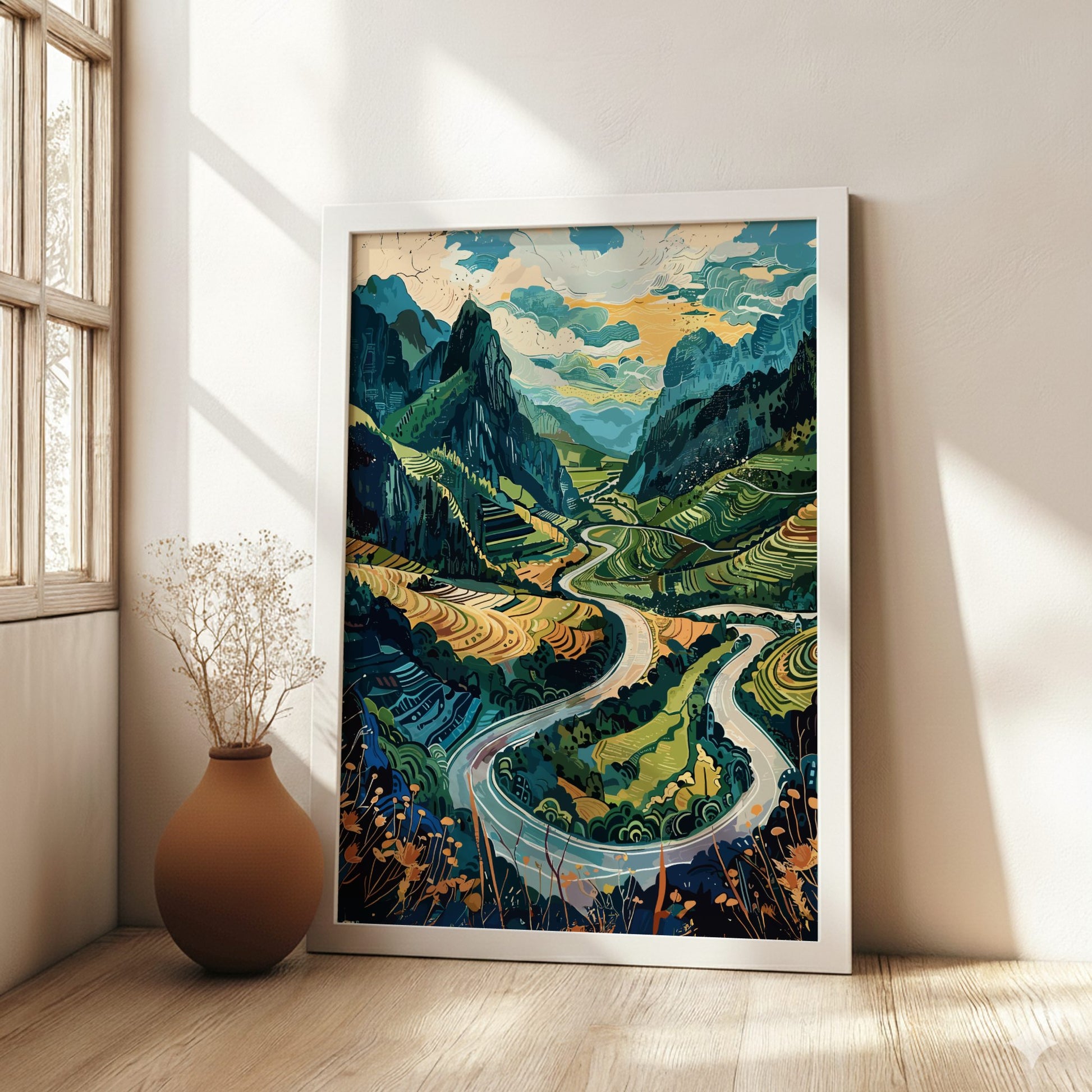 Framed artwork of a mountain landscape with a river in a room with a vase on the floor.