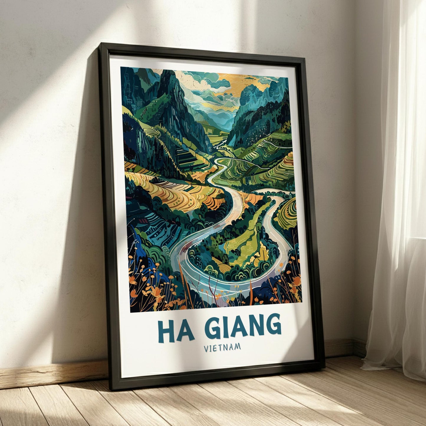 Framed artwork of a scenic landscape with winding road and mountains, labeled 'Ha Giang Vietnam' on a white wall.