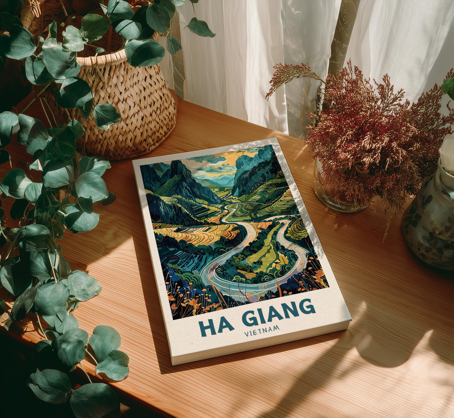 Canvas 'Ha Giang Vietnam' on a wooden table with decorative plants.