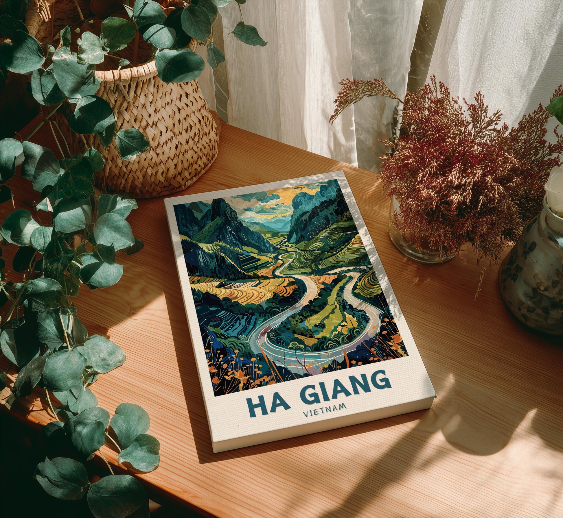Canvas 'Ha Giang Vietnam' on a wooden table with decorative plants.