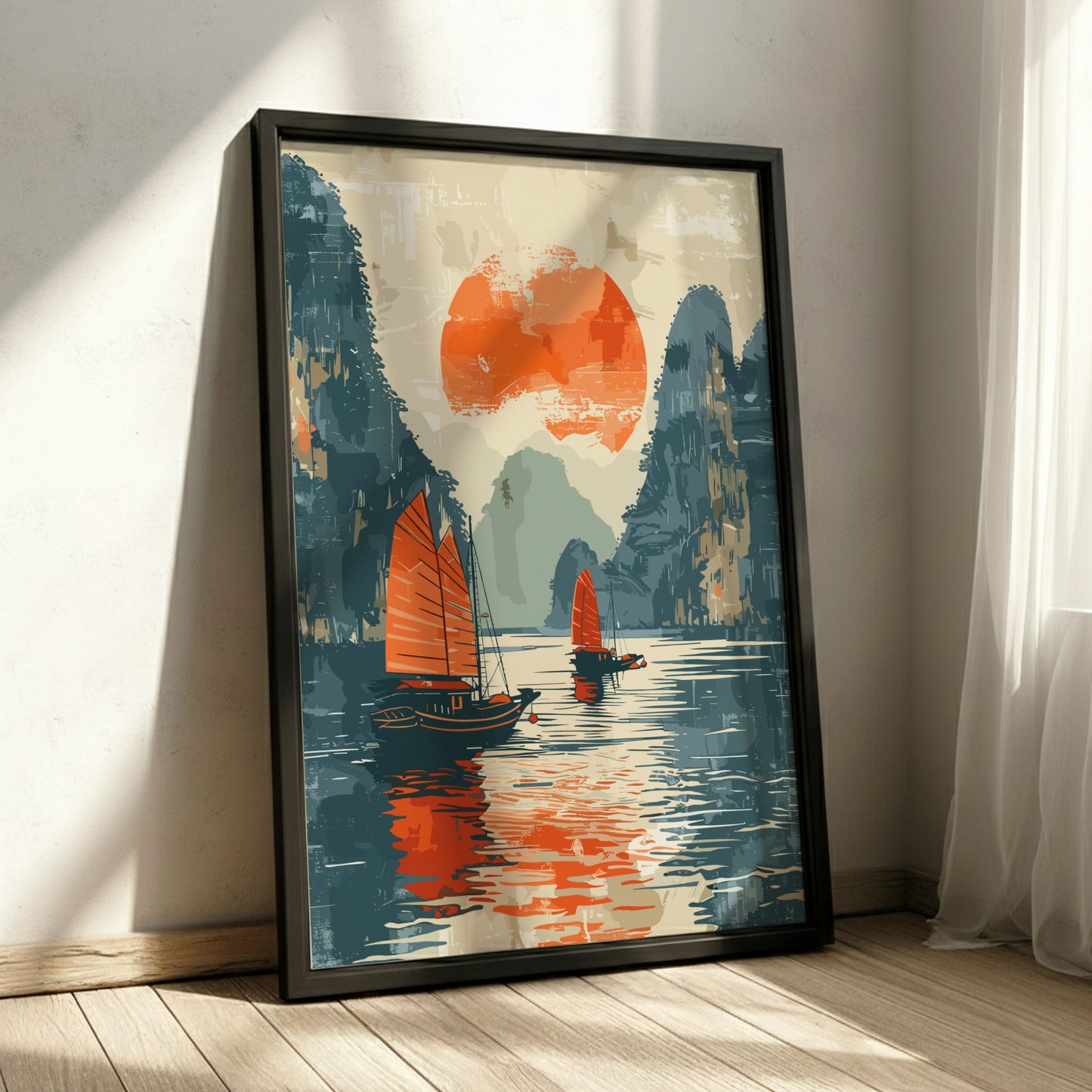 Framed artwork of sailboats on a lake with mountains and a red sun.