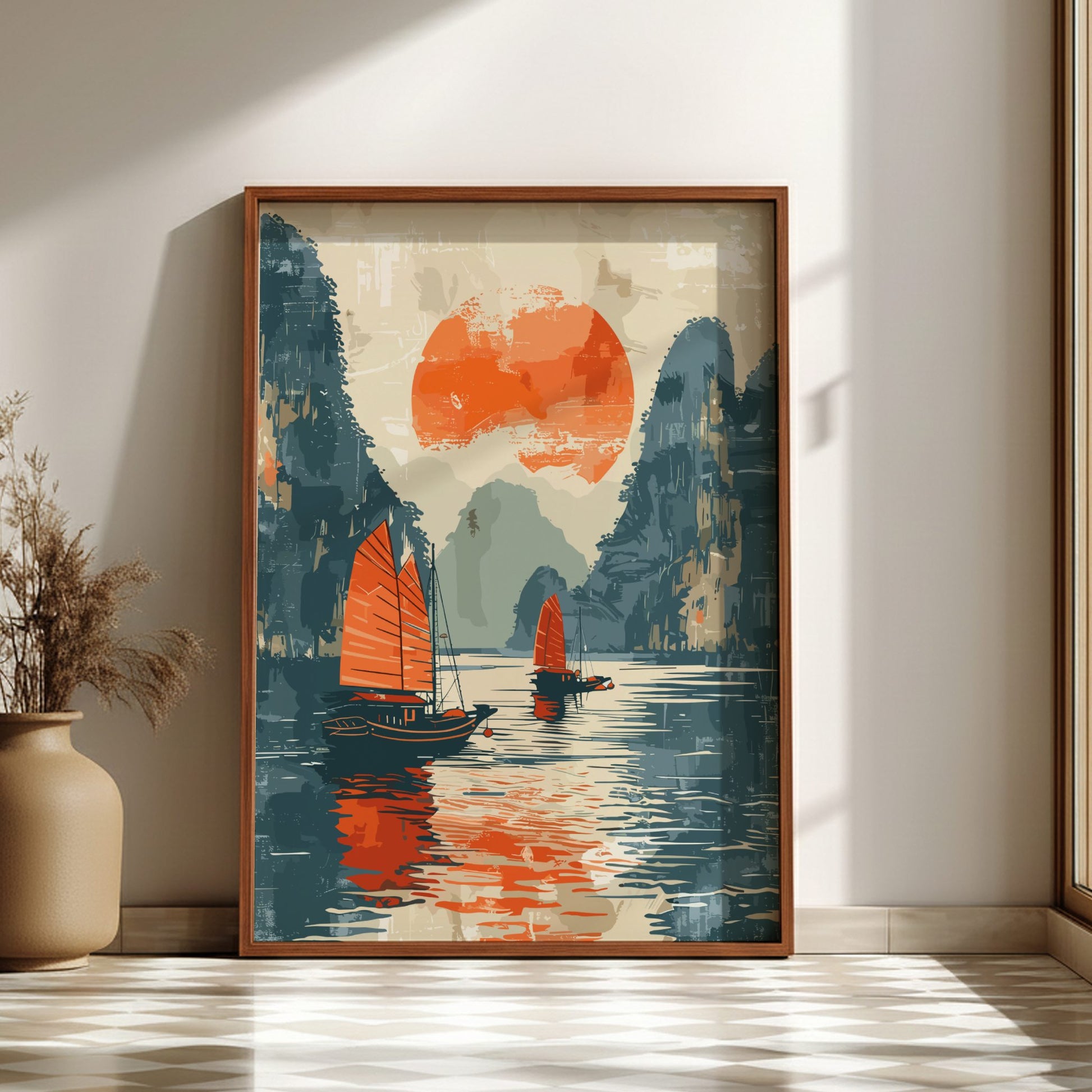 Framed artwork of two sailboats on water with a red sun and mountains, displayed on a wall.