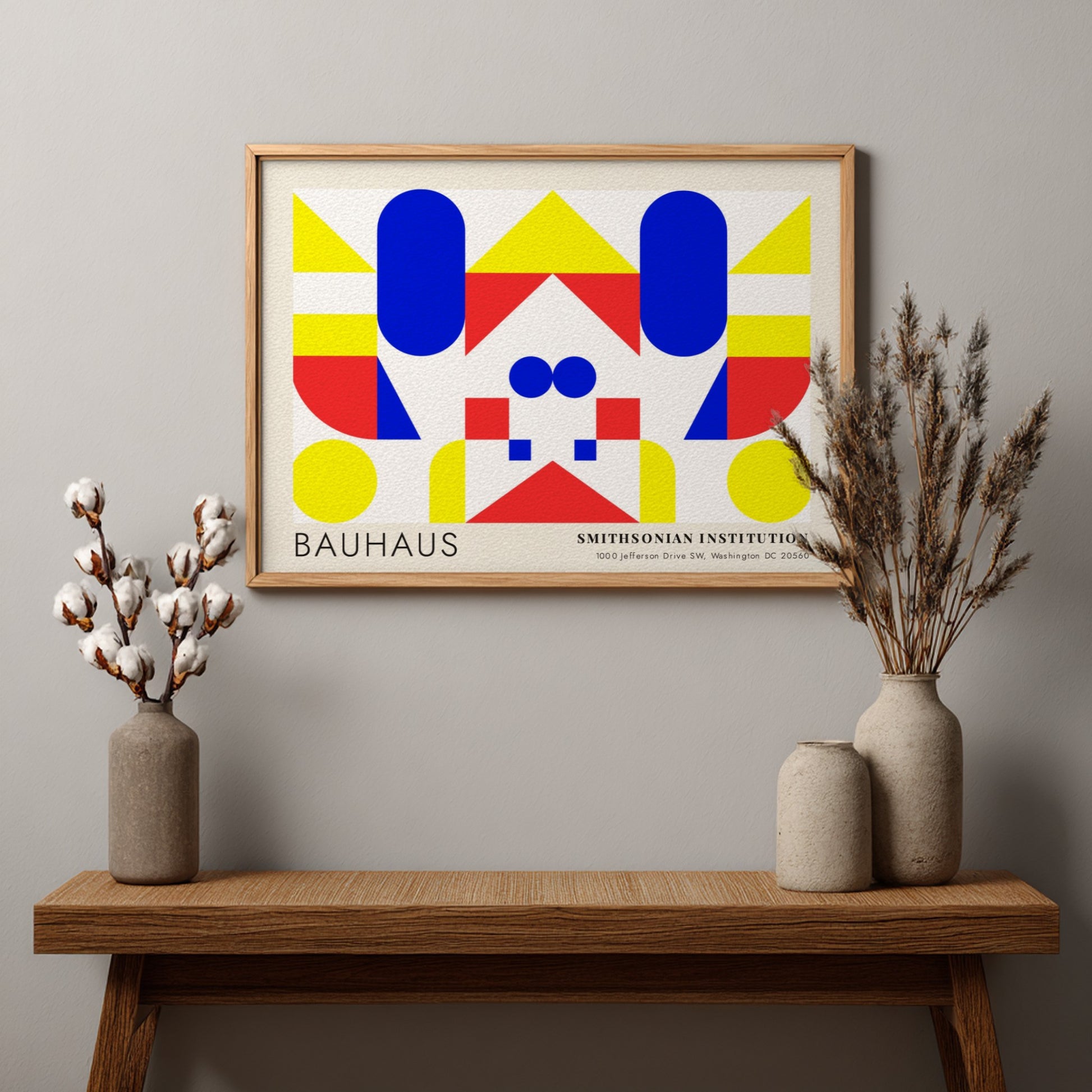 Bauhaus exhibition poster featuring geometric shapes in yellow red and blue by Herbert Bayer
