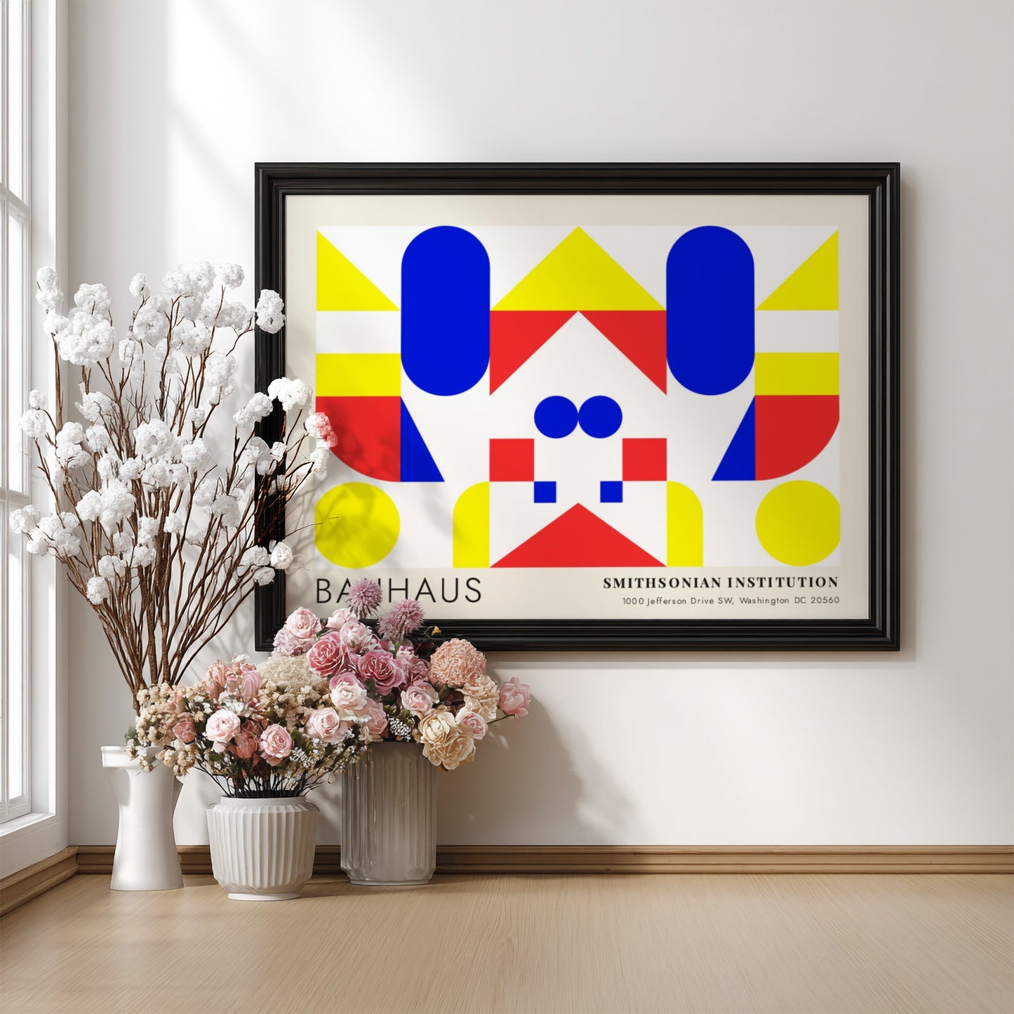 Bauhaus exhibition poster featuring geometric shapes in yellow red and blue by Herbert Bayer