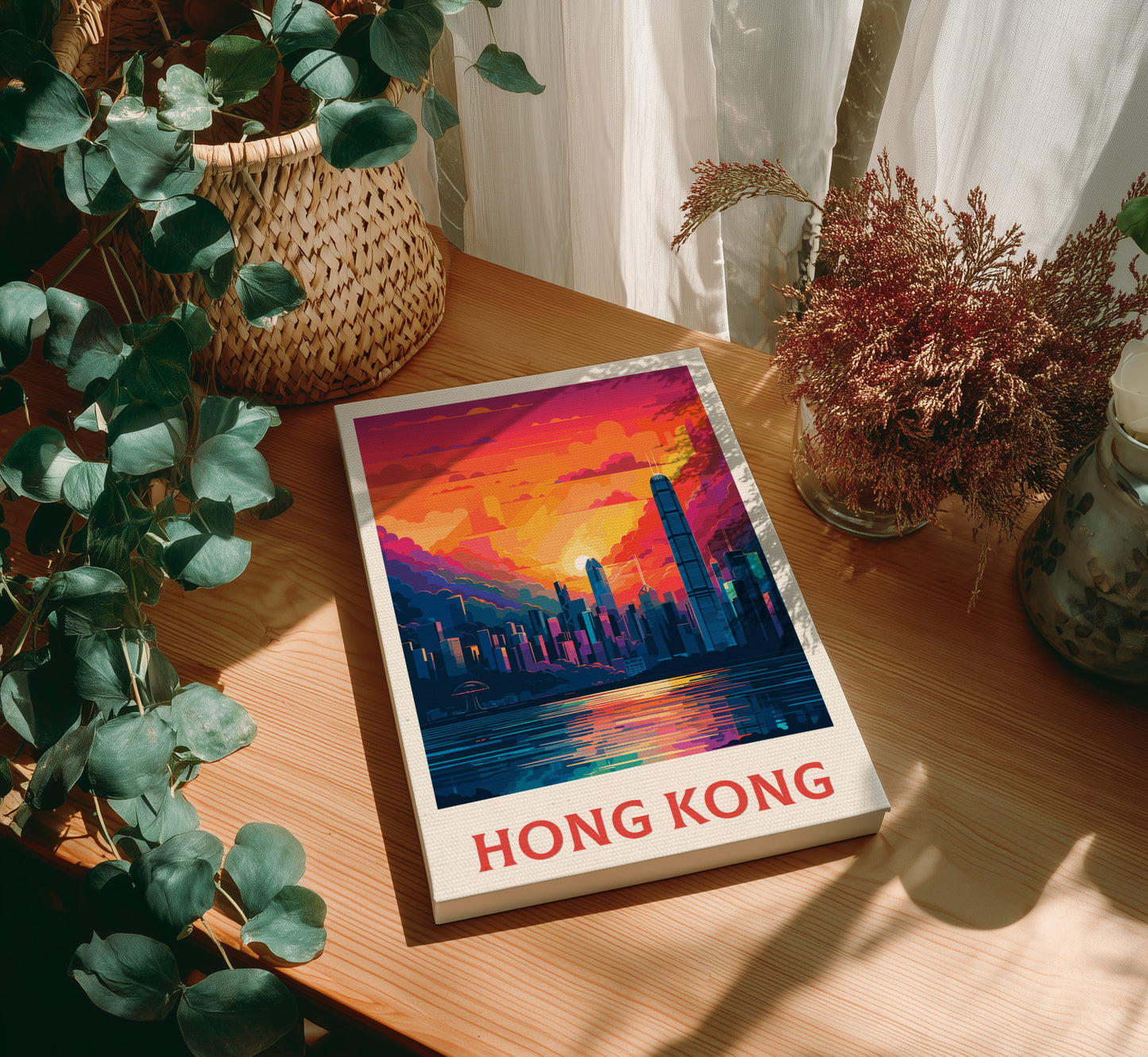 Canvas 'Hong Kong' with a cityscape illustration on a wooden table with plants.