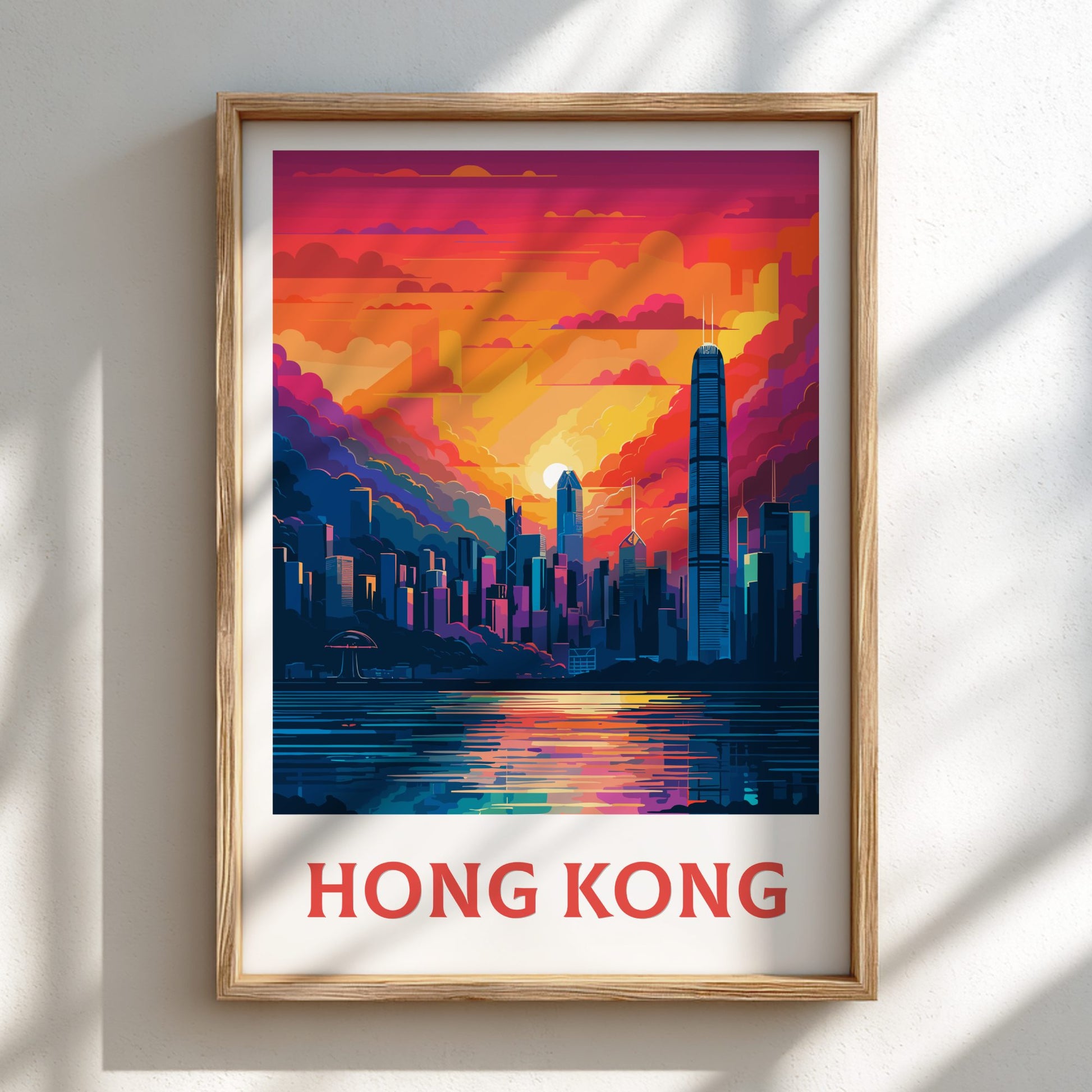 Framed artwork of a city skyline with 'Hong Kong' text on a white wall.
