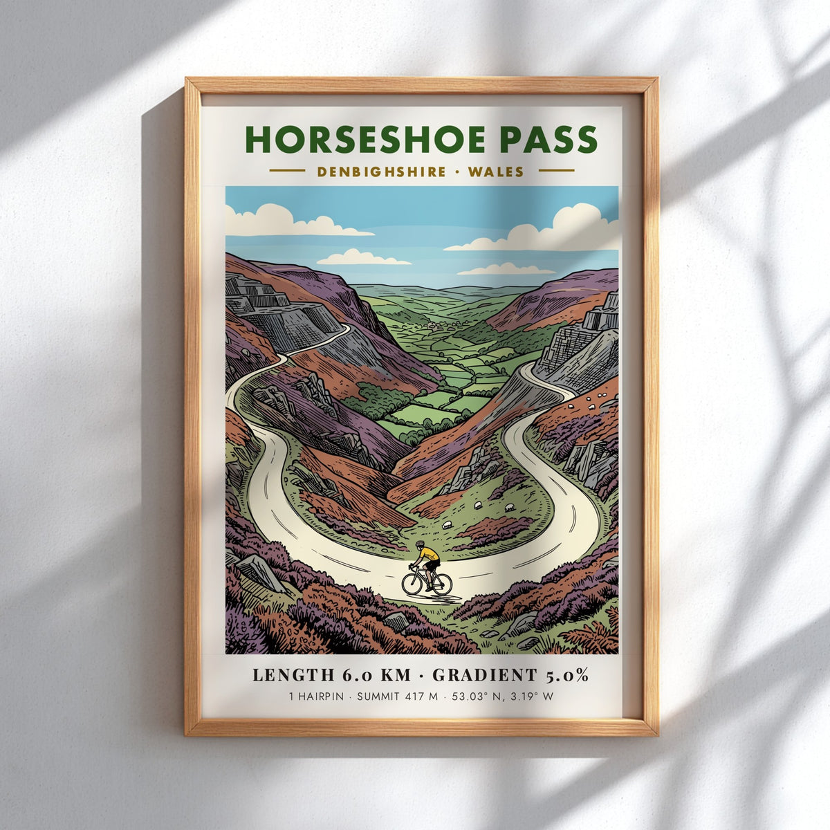 Poster of Horseshoe Pass in Denbighshire featuring a cyclist on a winding road