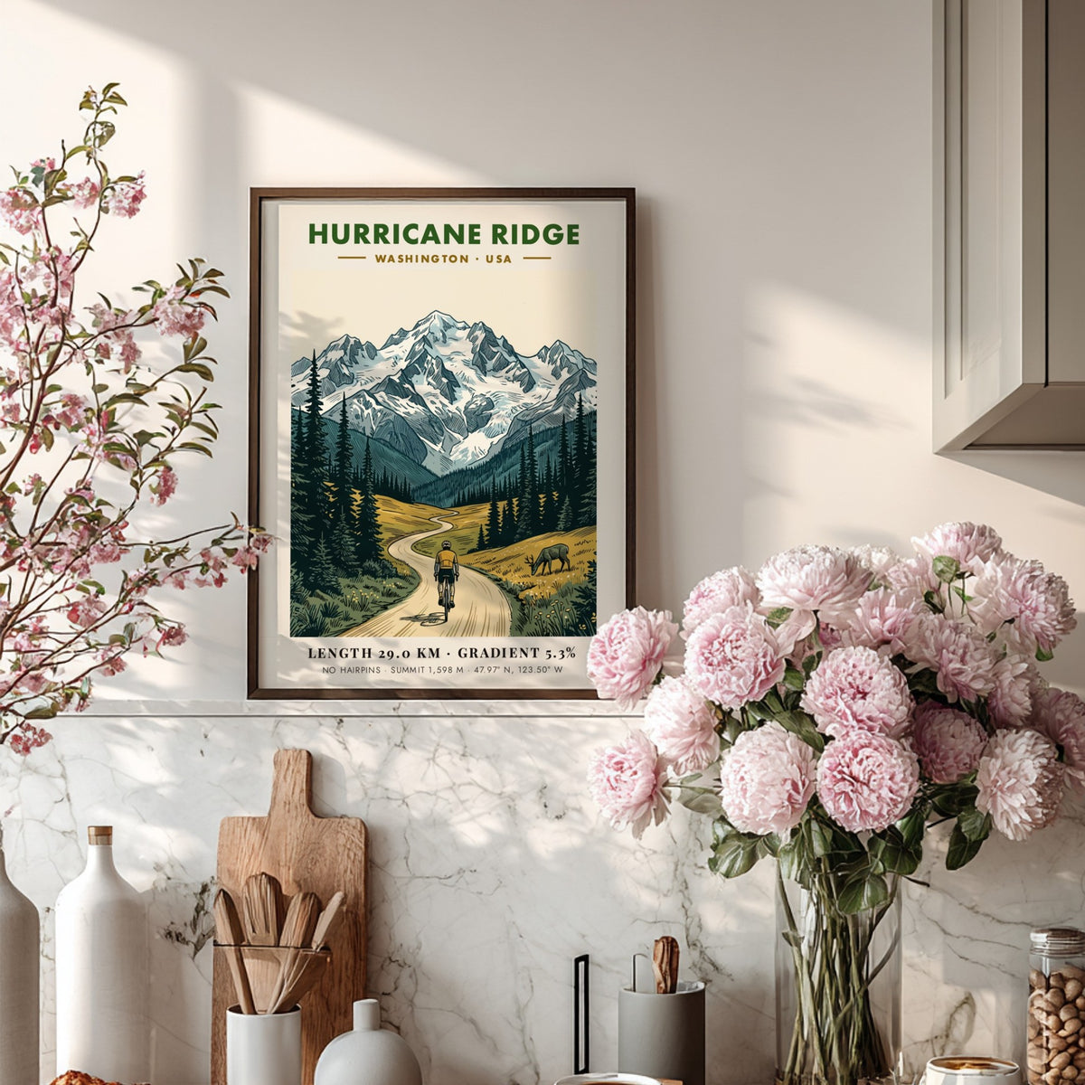 Poster of a cyclist climbing a winding road toward snow-capped Hurricane Ridge mountains.