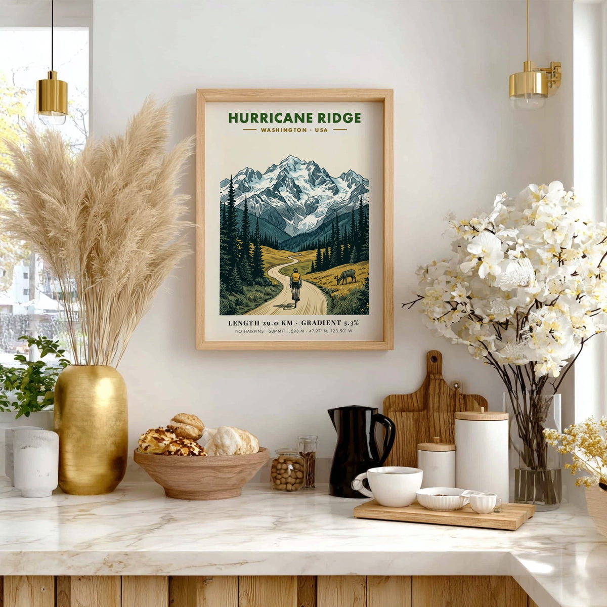 Poster of a cyclist climbing a winding road toward snow-capped Hurricane Ridge mountains.