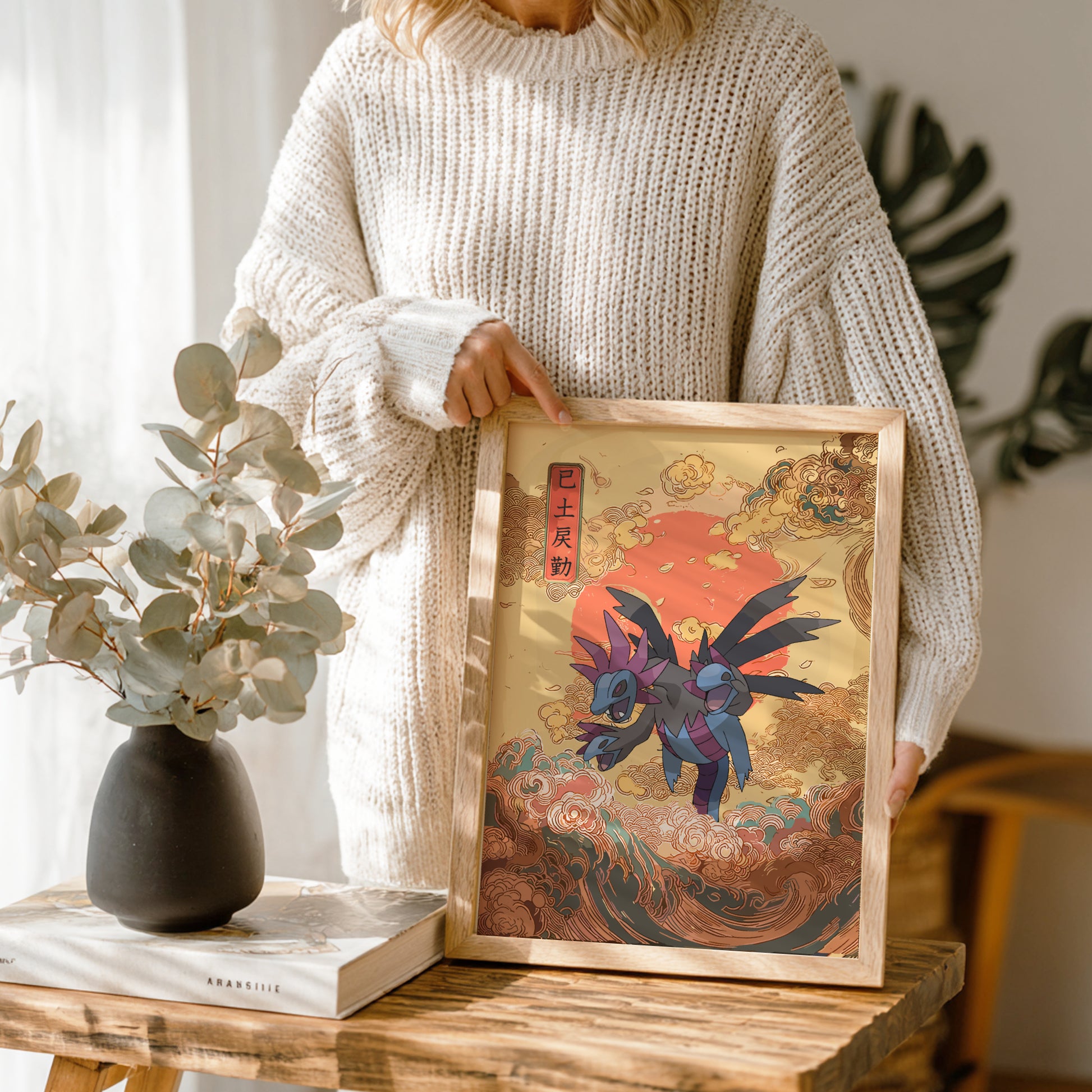 Person holding a framed artwork ofHydreigon Pokemon with a warm color palette.