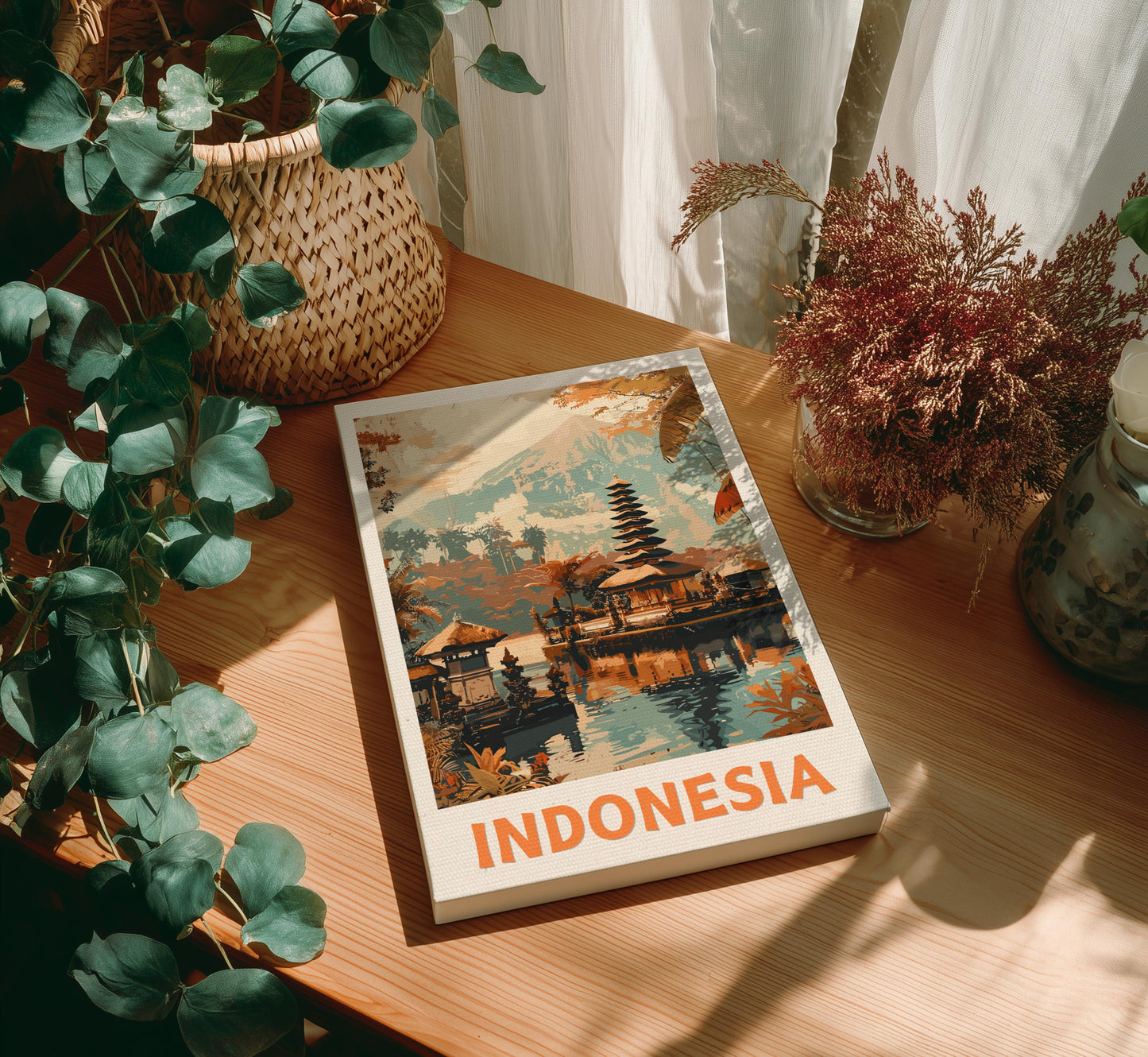 Canvas of 'Indonesia' on a wooden table with plants around 