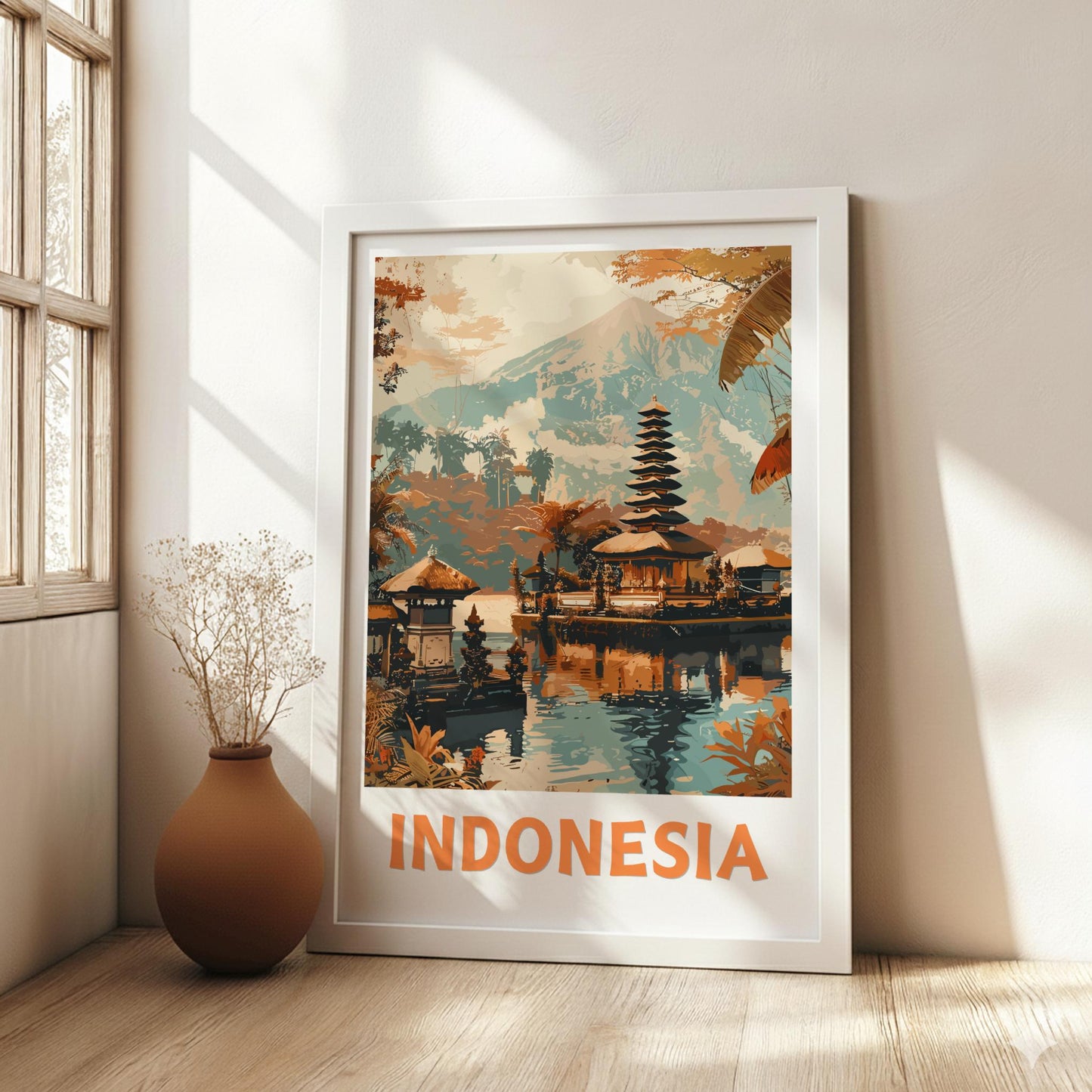 Framed artwork of a temple in Indonesia on a wall with natural light.