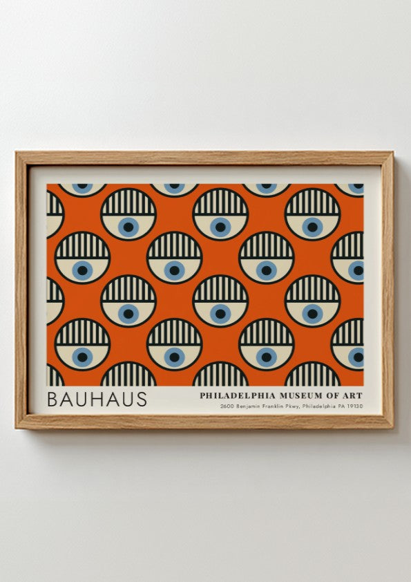 Bauhaus Philadelphia Museum of Art poster featuring repeating circular eye motifs on orange.