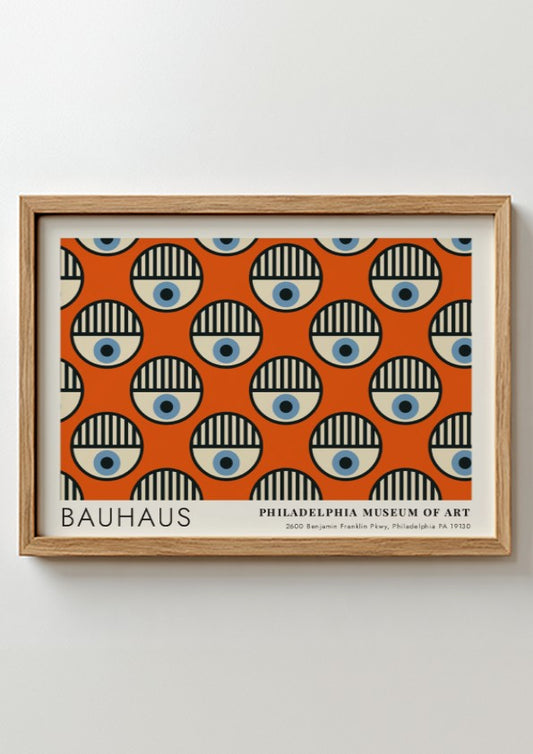 Bauhaus Philadelphia Museum of Art poster featuring repeating circular eye motifs on orange.