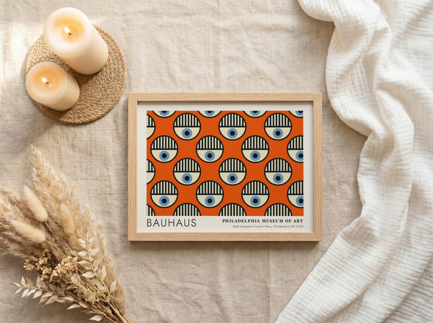 Bauhaus Philadelphia Museum of Art poster featuring repeating circular eye motifs on orange.