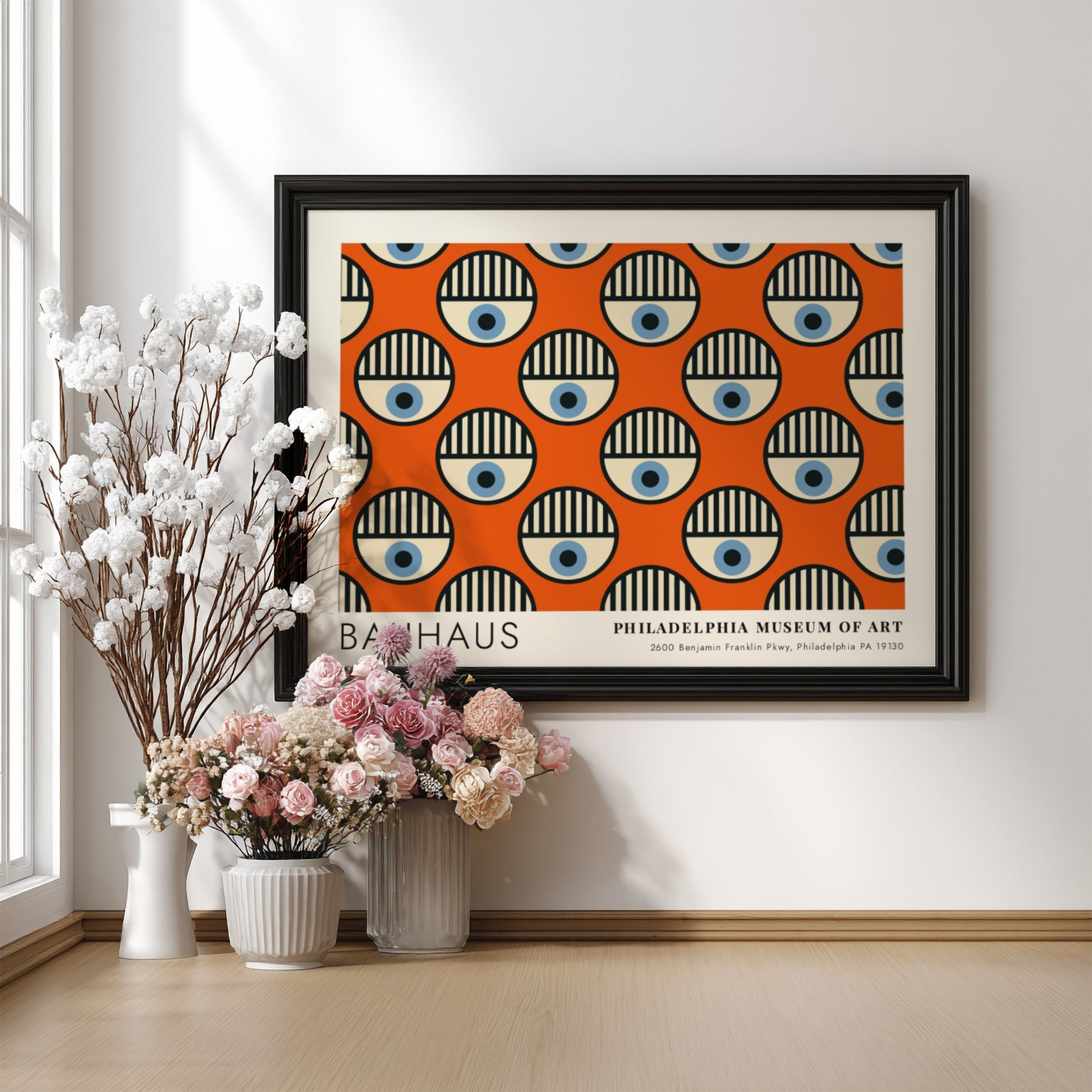 Bauhaus Philadelphia Museum of Art poster featuring repeating circular eye motifs on orange.