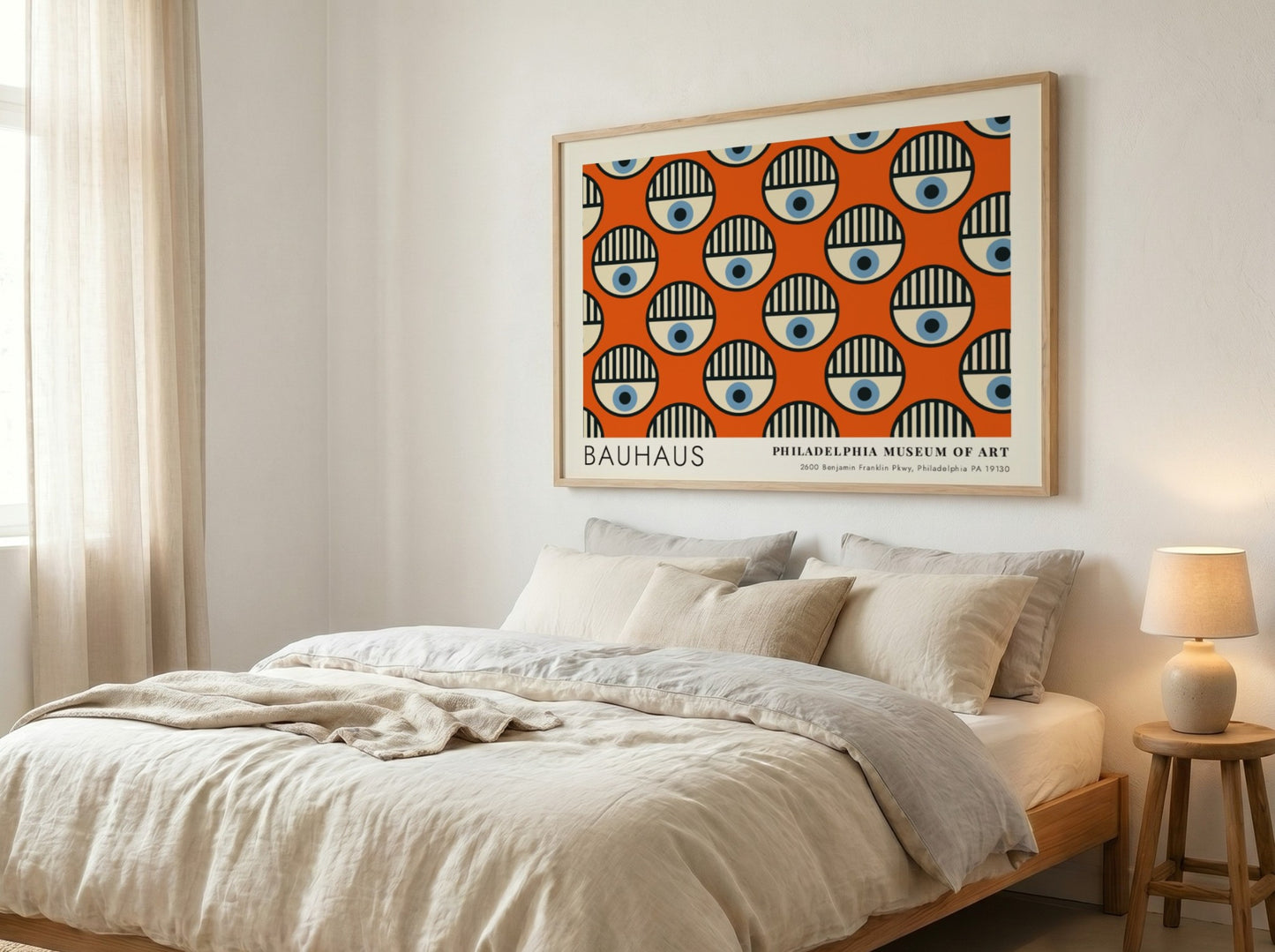 Bauhaus Philadelphia Museum of Art poster featuring repeating circular eye motifs on orange.