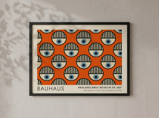 Bauhaus Philadelphia Museum of Art poster featuring repeating circular eye motifs on orange.