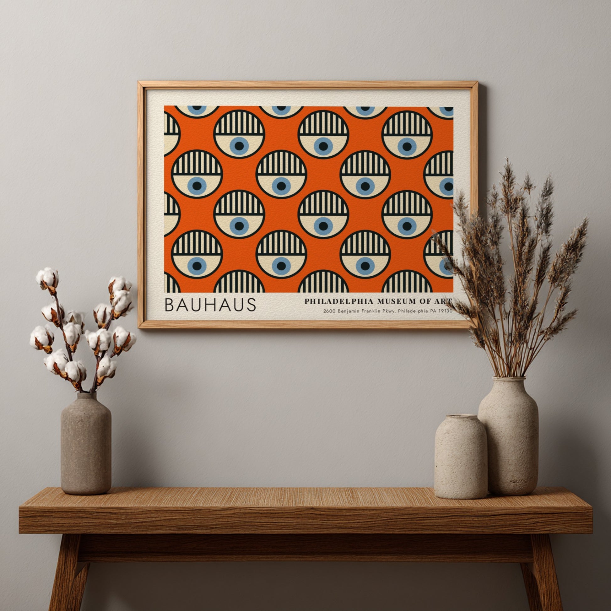 Bauhaus Philadelphia Museum of Art poster featuring repeating circular eye motifs on orange.