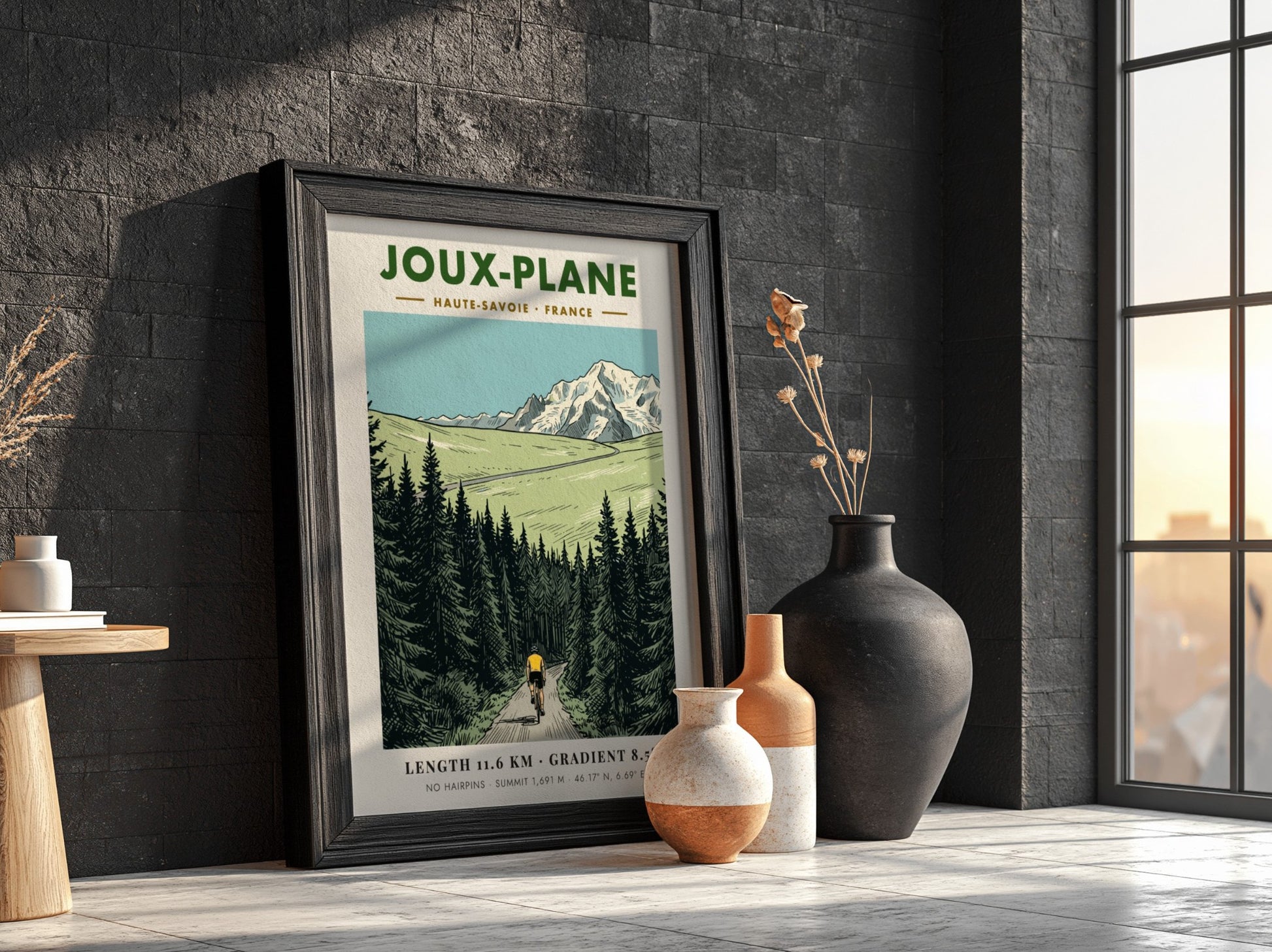 Poster of a cyclist climbing the winding road toward the snowy Joux-Plane mountain.